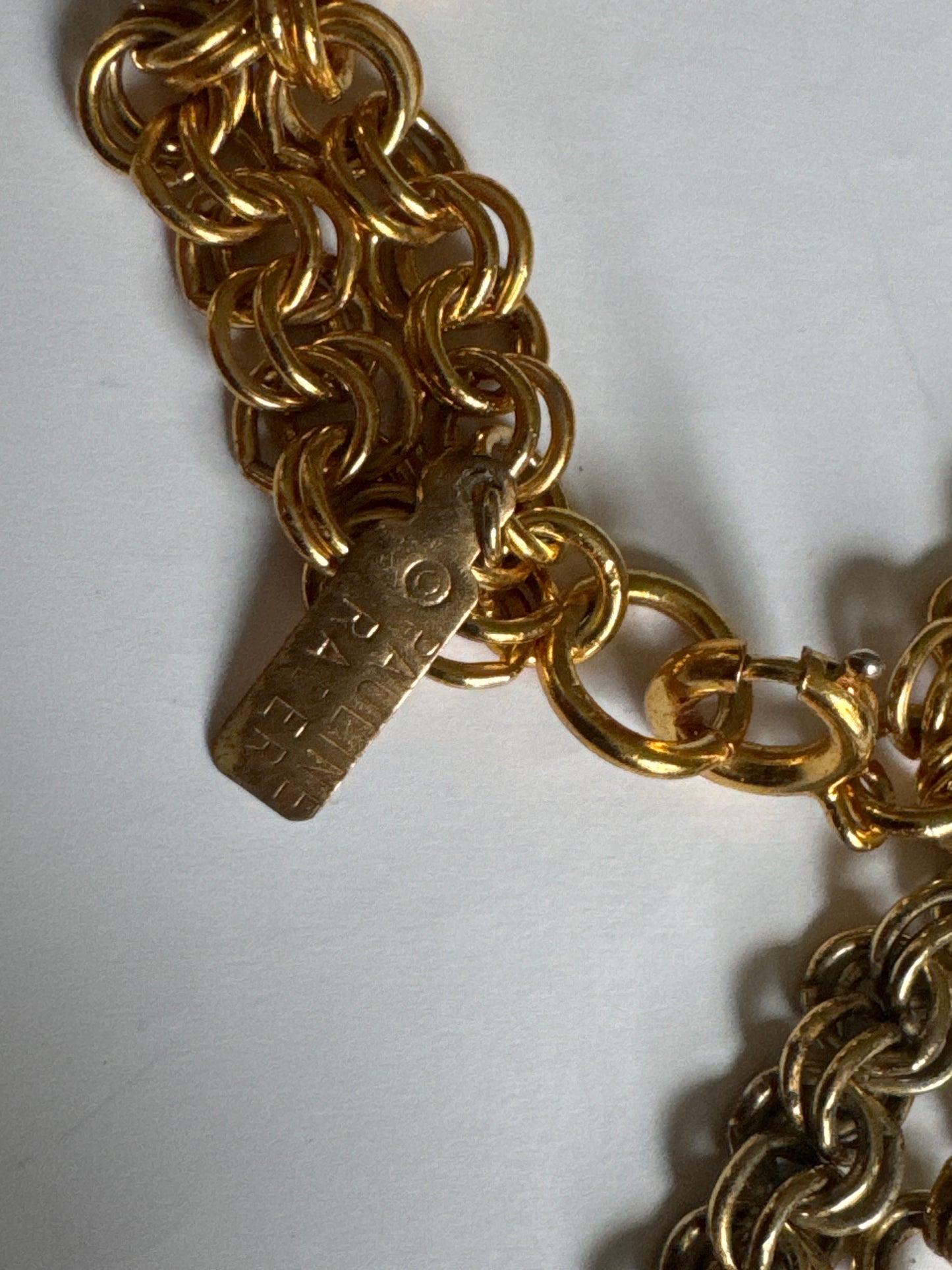 Signed 1960s Pauline Rader signed gold tone necklace. The two elephant heads that dangle at the bottom of the pendant are hollow. Double chains on each side. It's heavy!