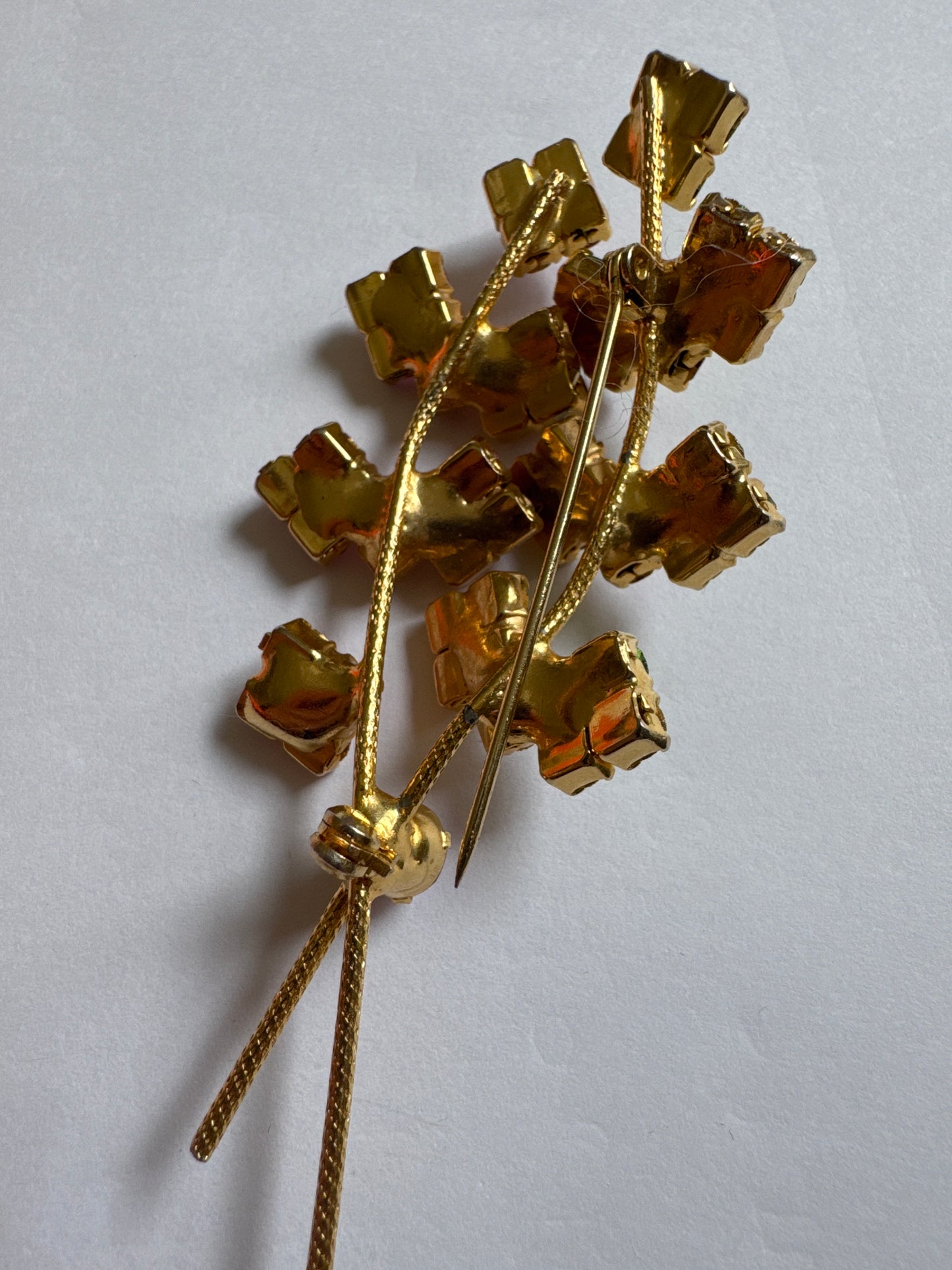Beautiful mid-century, floral spray, brooch featuring pink and green rhinestones on a gold tone back