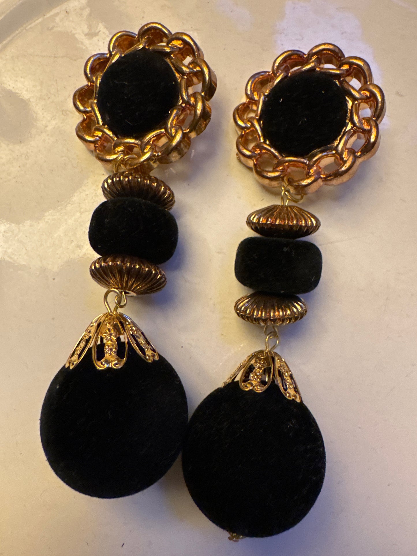 jumbo lightweight, gold tone, vintage pom-pom earrings. Black pom-poms. Sourced in Paris.