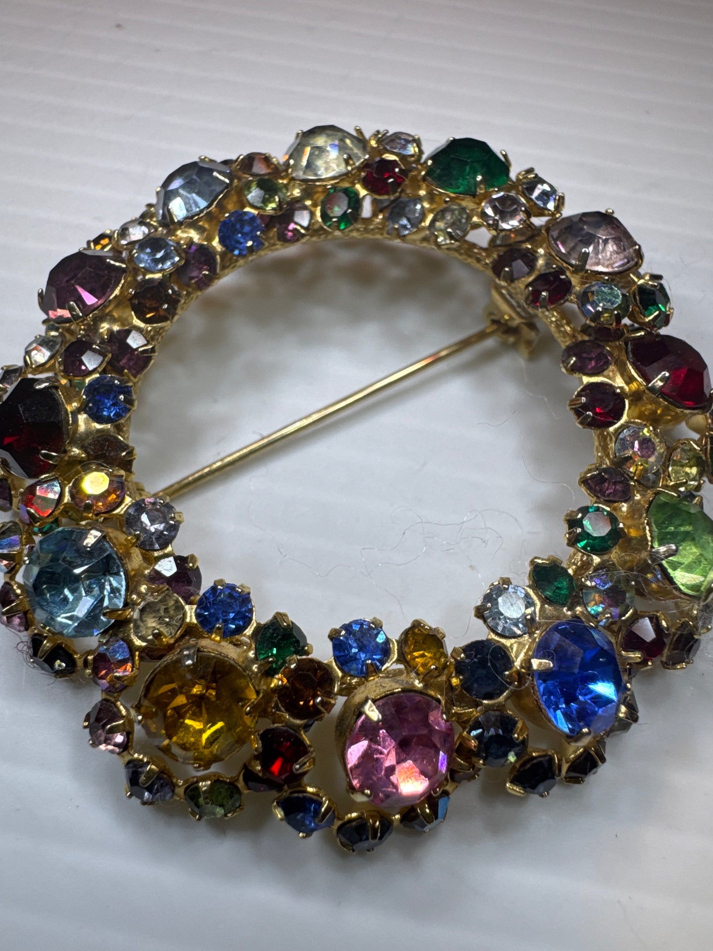 1940s unsigned, rainbow colored rhinestone wreath brooch