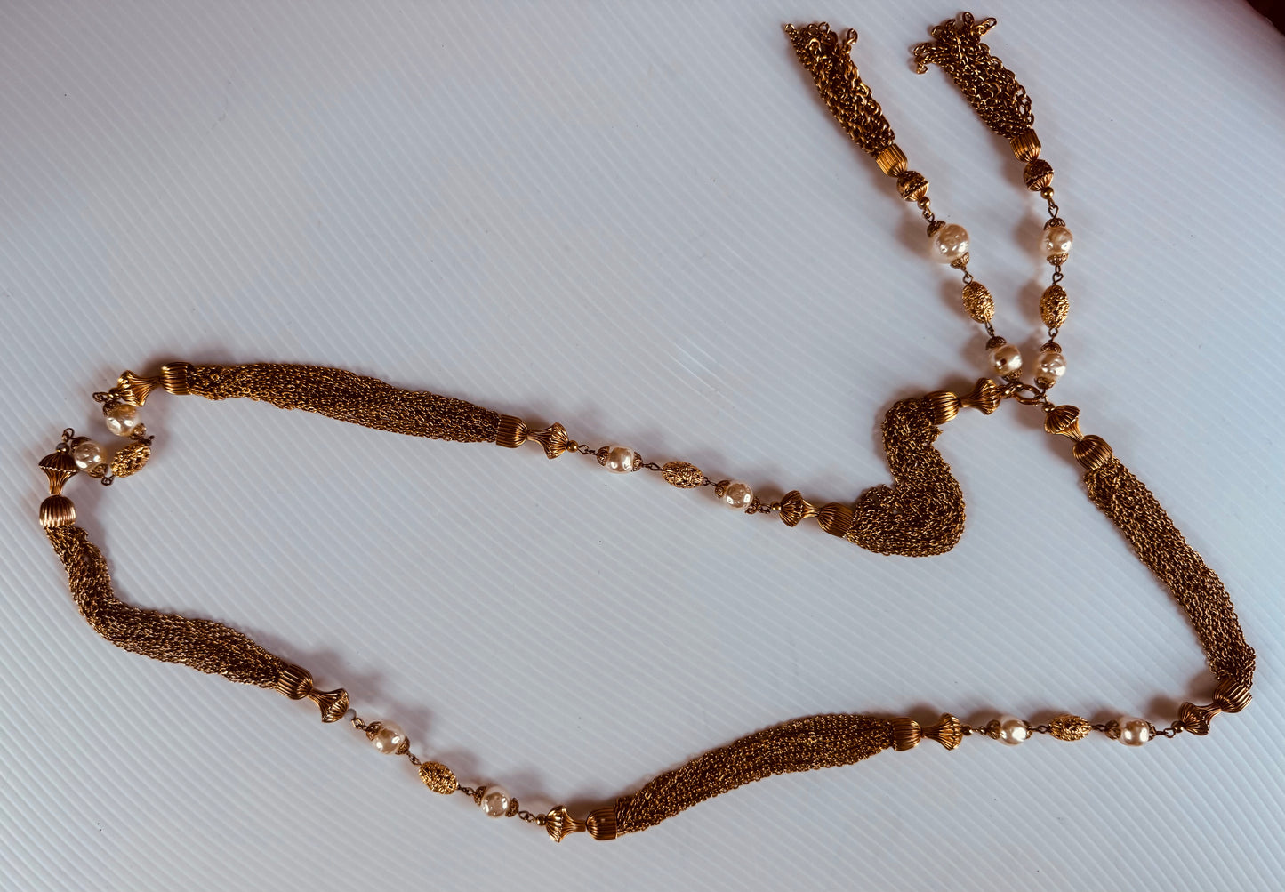 Gorgeous vintage Chanel inspired gold tone and pearl chain necklace. Tassel hangs down the back. Note some beads have chipped gold. Sourced in Paris.