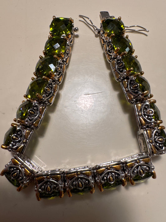 Beautiful, signed Park Lane bracelet olive colored rhinestones on a silver rhodium and gold to base grade measure 7 inches