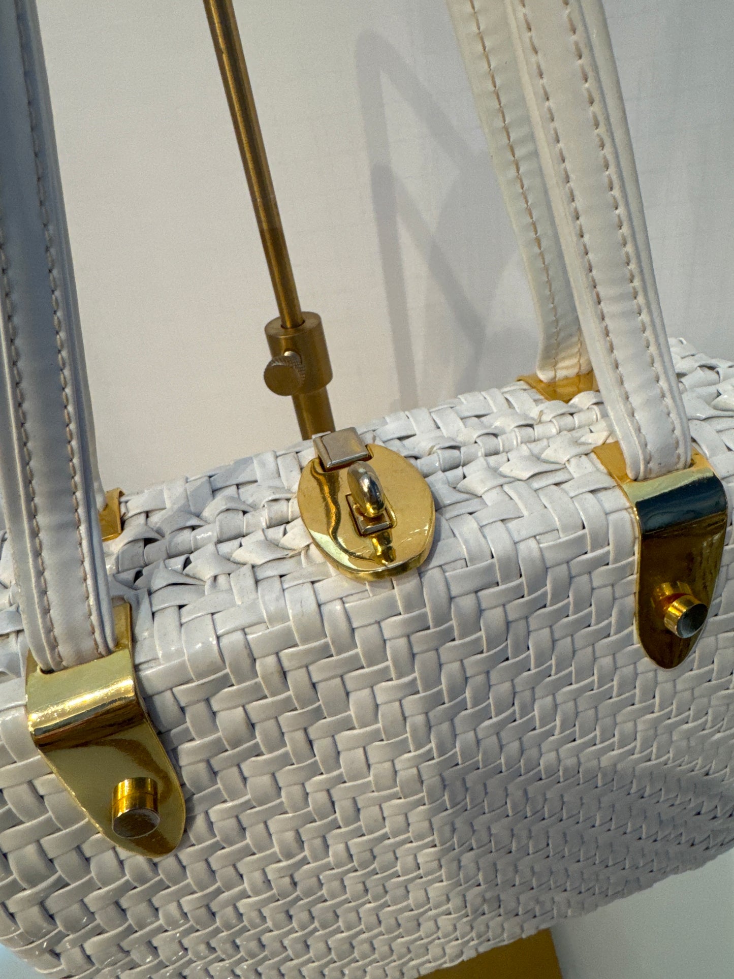 The perfect spring and summer white wicker bag with vinyl top handle.