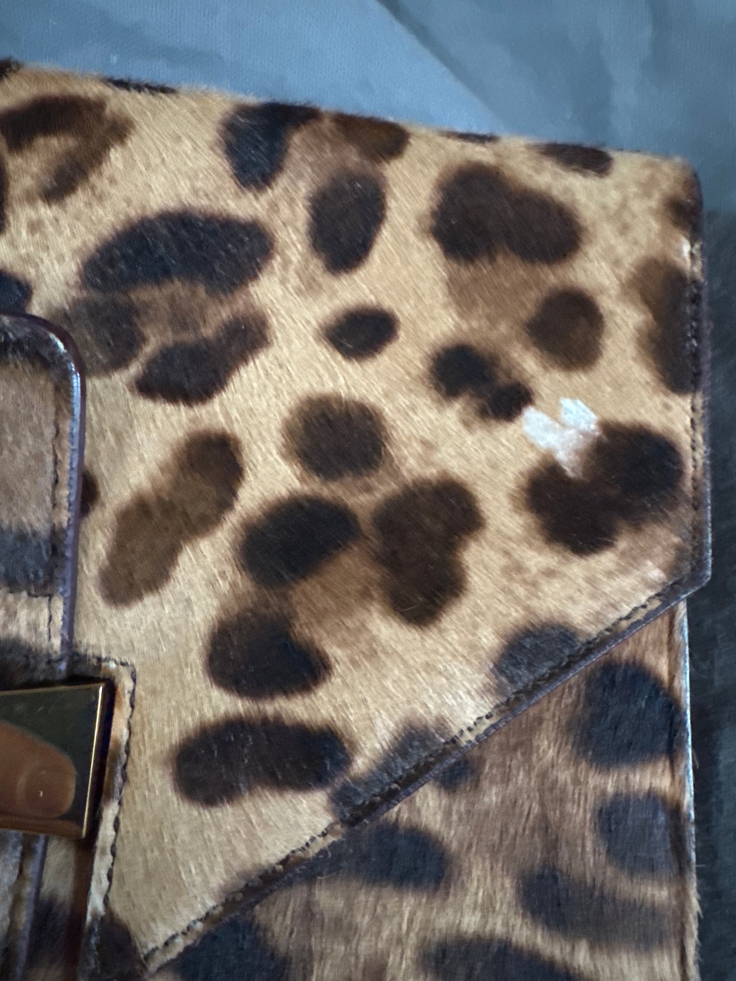 Alexander McQueen pony hair clutch with gold hardware, burgundy suede interior and gold hardware