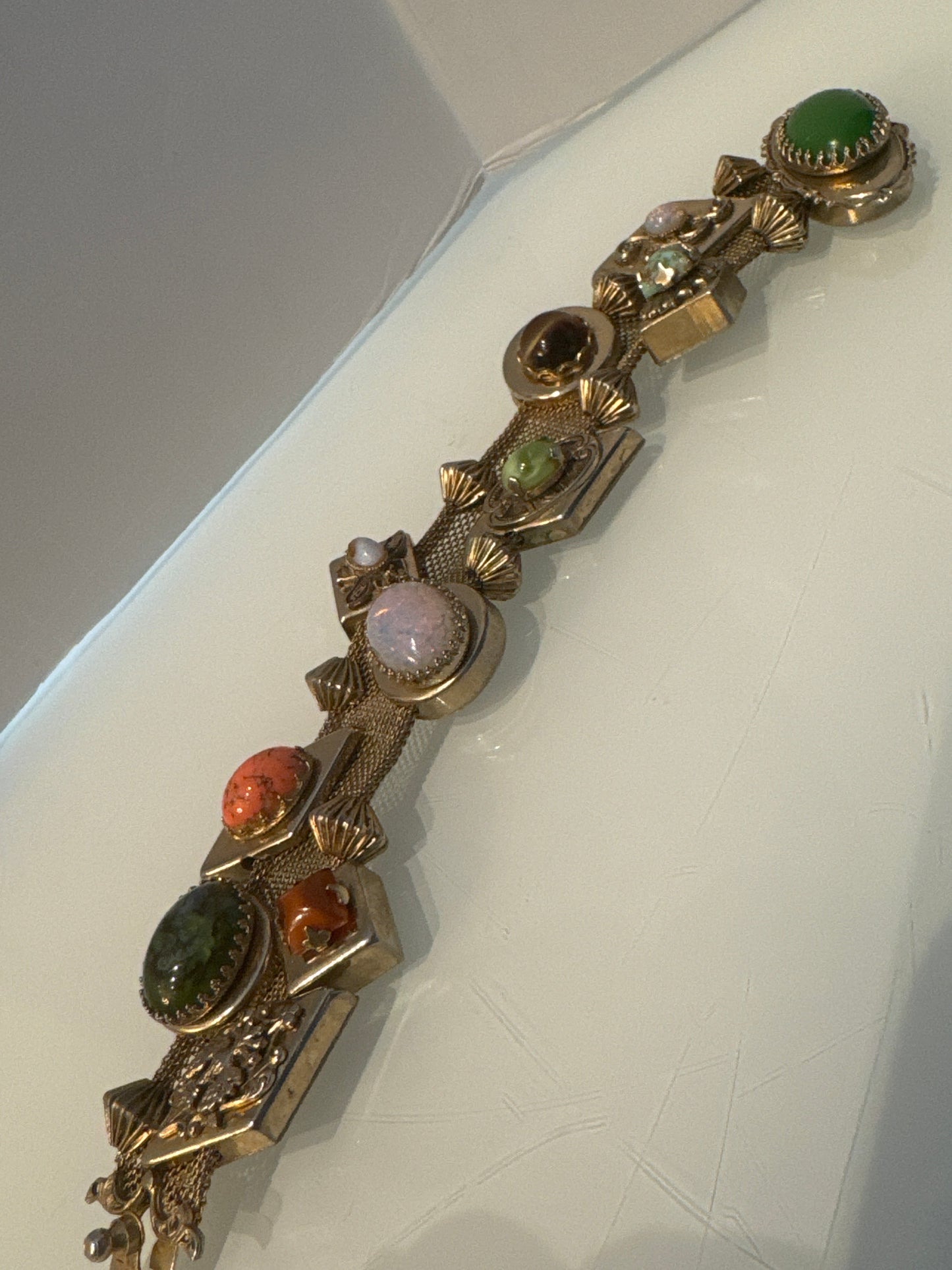 Stunning wire gold tone slider bracelet with over 10 charms. Sourced in Paris.