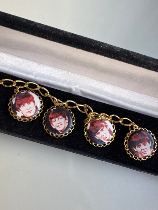 Amazing 1970s charm bracelet featuring pictures of the Beatles, Paul, George Ringo, and John with their names on the back of each charm. Tom