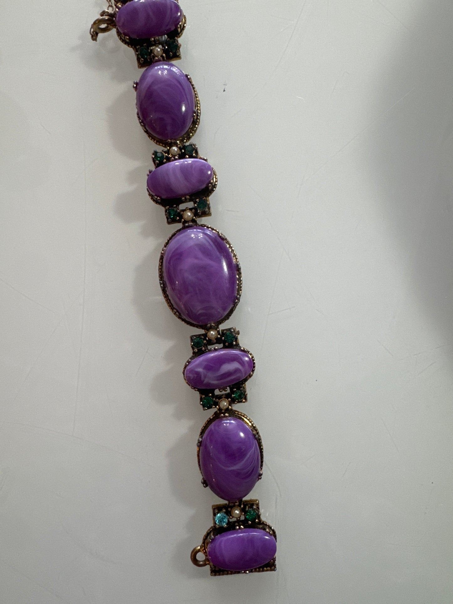 Stunning 1950s bracelet. Gold tone with purple stones and green rhinestones and pearls