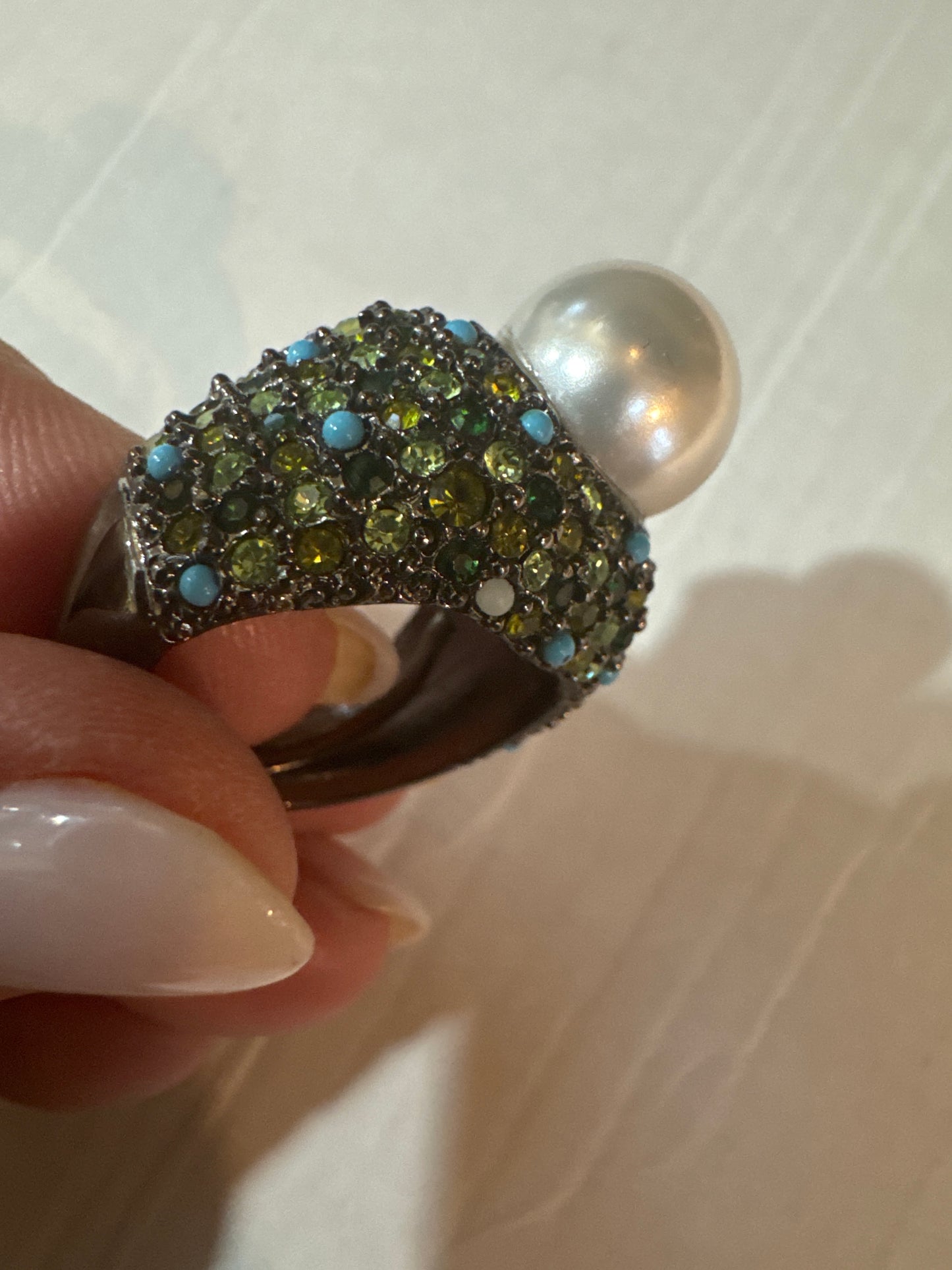 Stunning vintage KJL cocktail ring with green colored rhinestones, turquoise stones and a jumbo center pearl