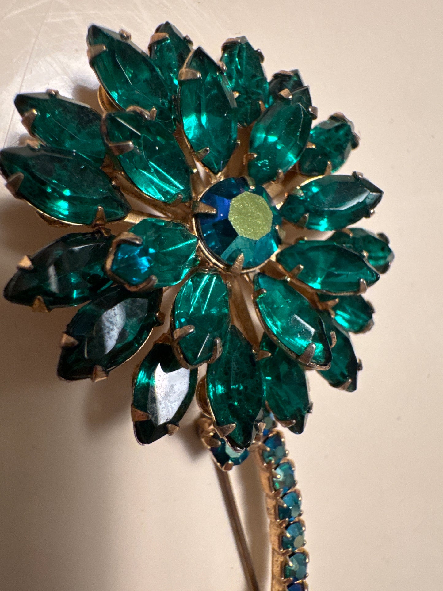 Beautiful 1950s/60s rhinestone brooch featuring Emerald rhinestones and aurora borealis. Measures 5 inches. Summer