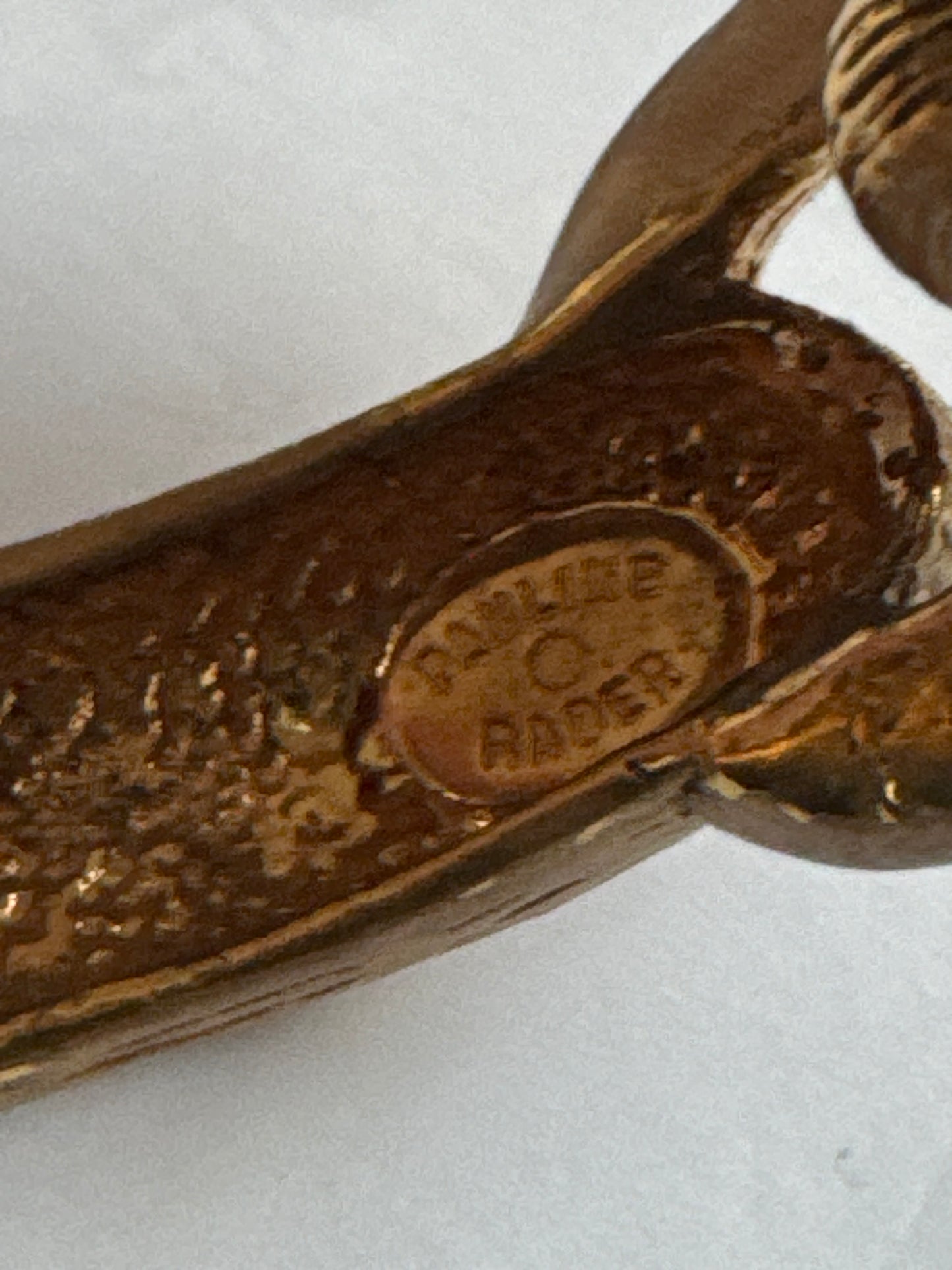 1960s signed PAULINE RADER gold tone ram clamper with ruby rhinestone eyes.