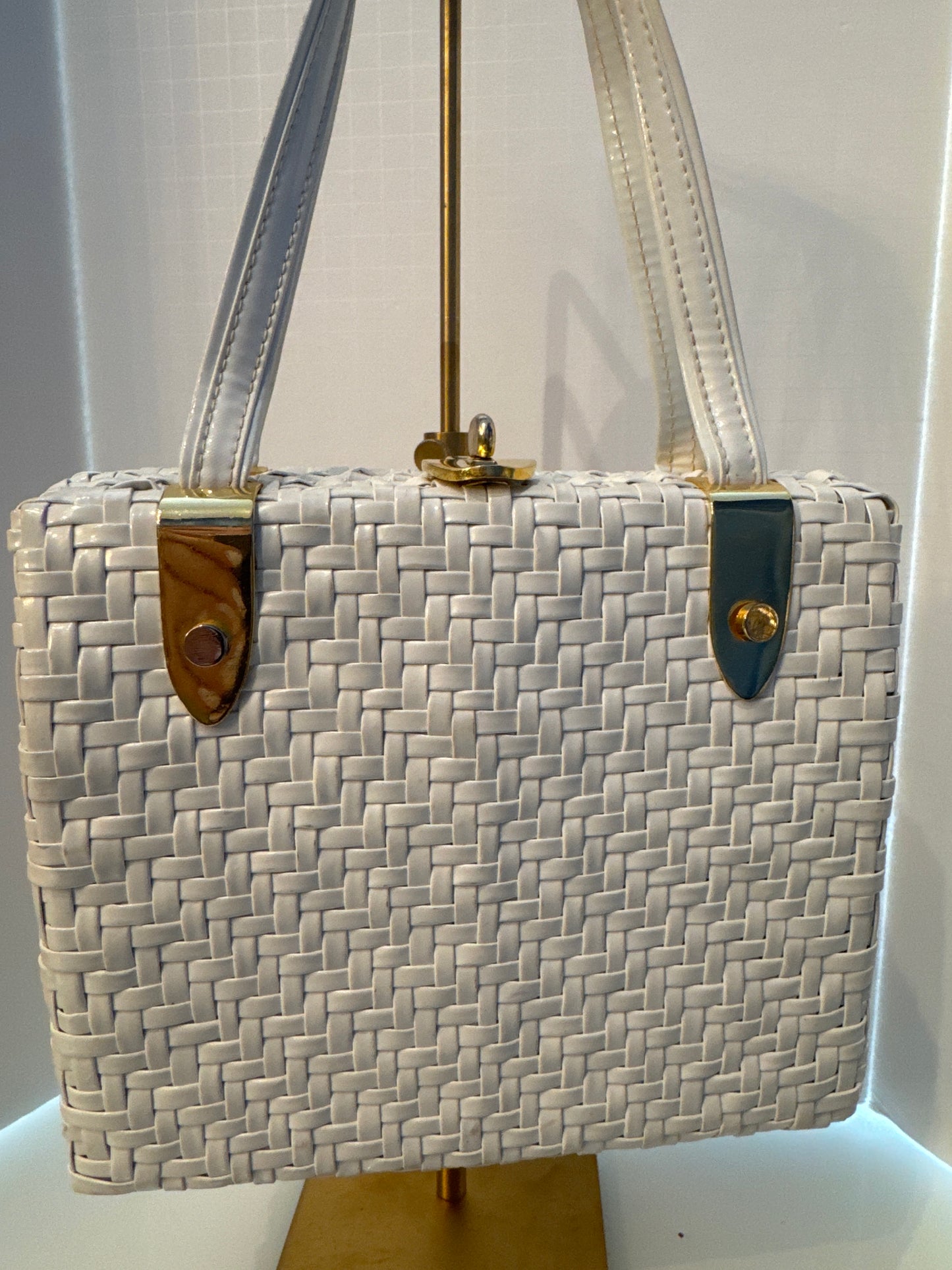 The perfect spring and summer white wicker bag with vinyl top handle.