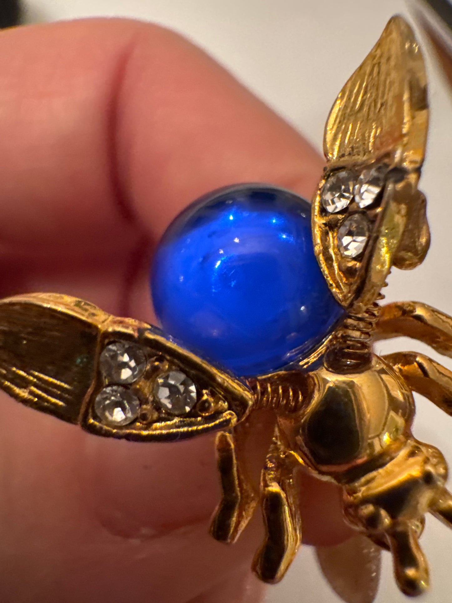 Unsigned vintage jelly belly trembler brooch attributed to Trifari (Alfred Philippe era), circa late 1940s, featuring a cobalt-blue glass cabochon body and spring-mounted tremble head. A RARE collectible.