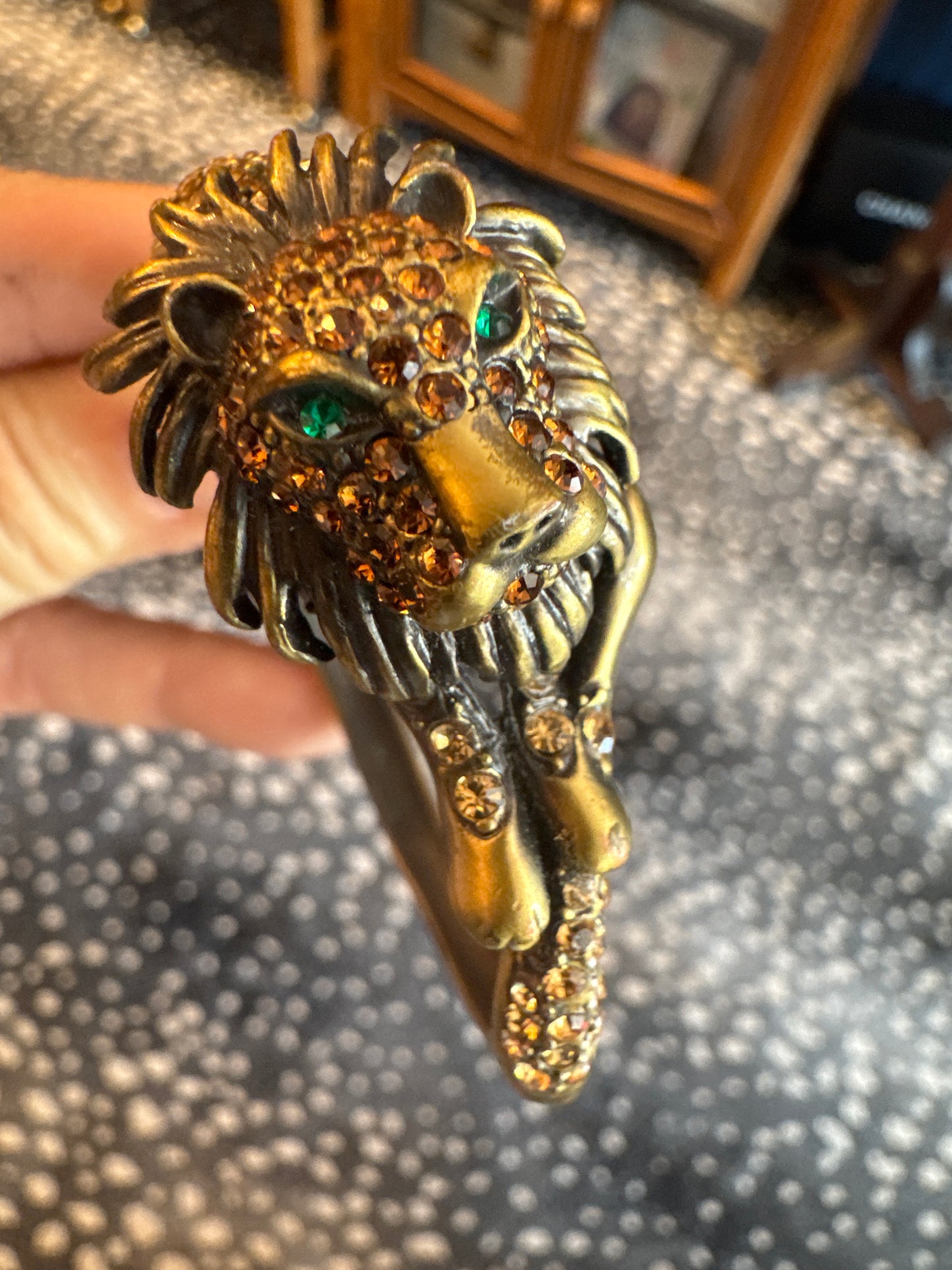 Beautiful vintage bronze, lion rhinestone clamper with green eyes