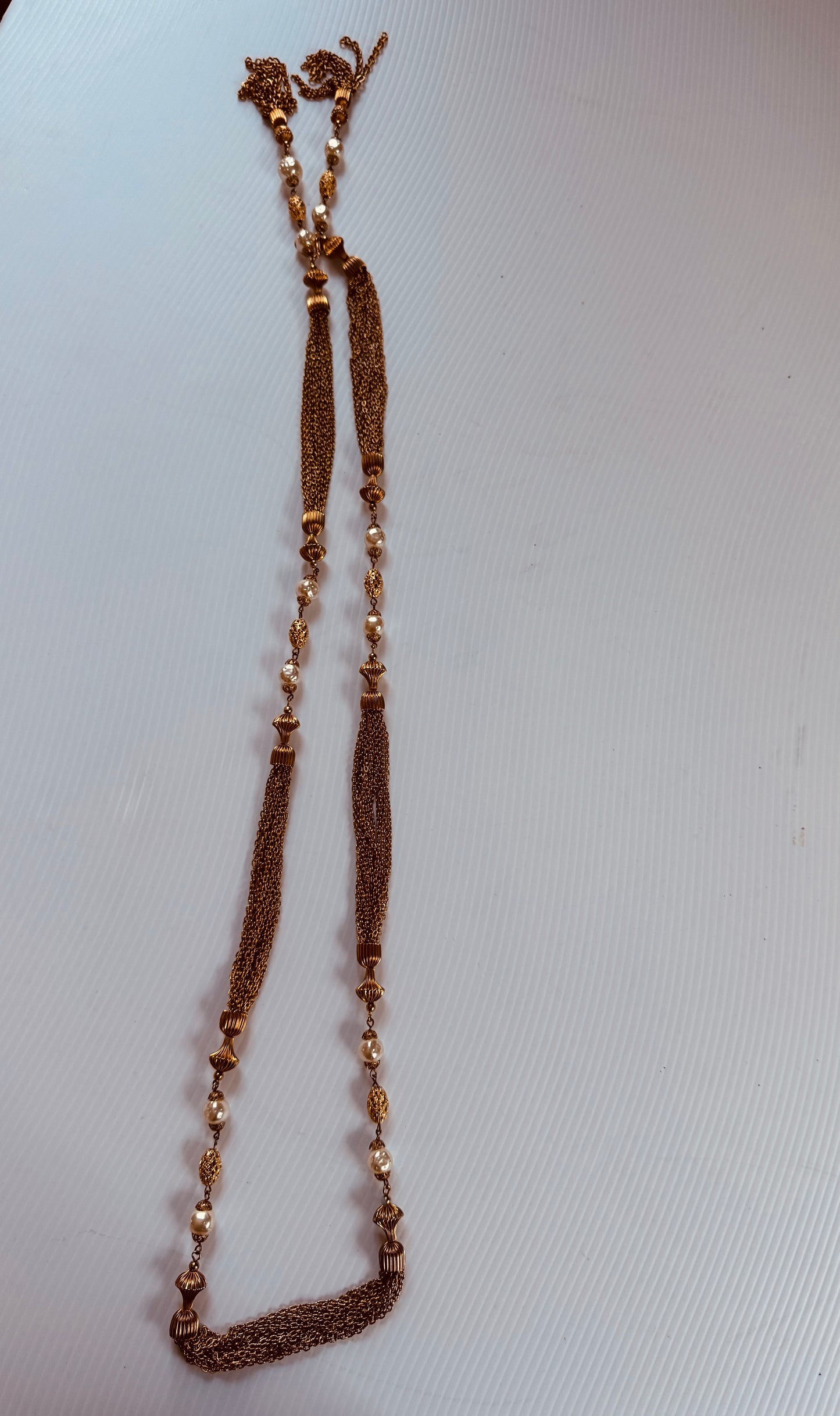 Gorgeous vintage Chanel inspired gold tone and pearl chain necklace. Tassel hangs down the back. Note some beads have chipped gold. Sourced in Paris.