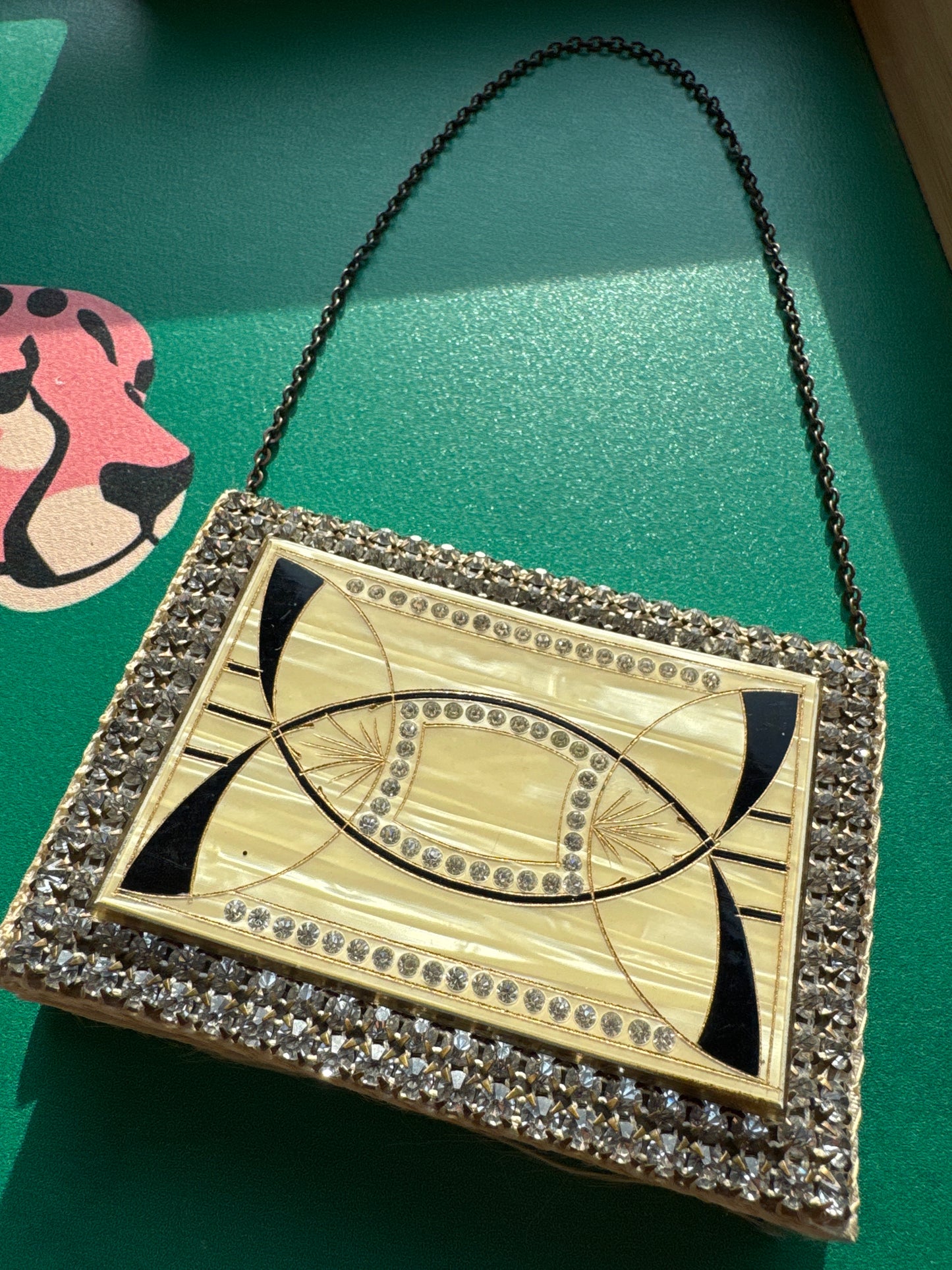 Beautiful rhinestone and enamel art deco 1920s modernist mini minaudiere with chain. Celluloid with geometric in layers, give it the jazz age glamour. Over 100 years old!