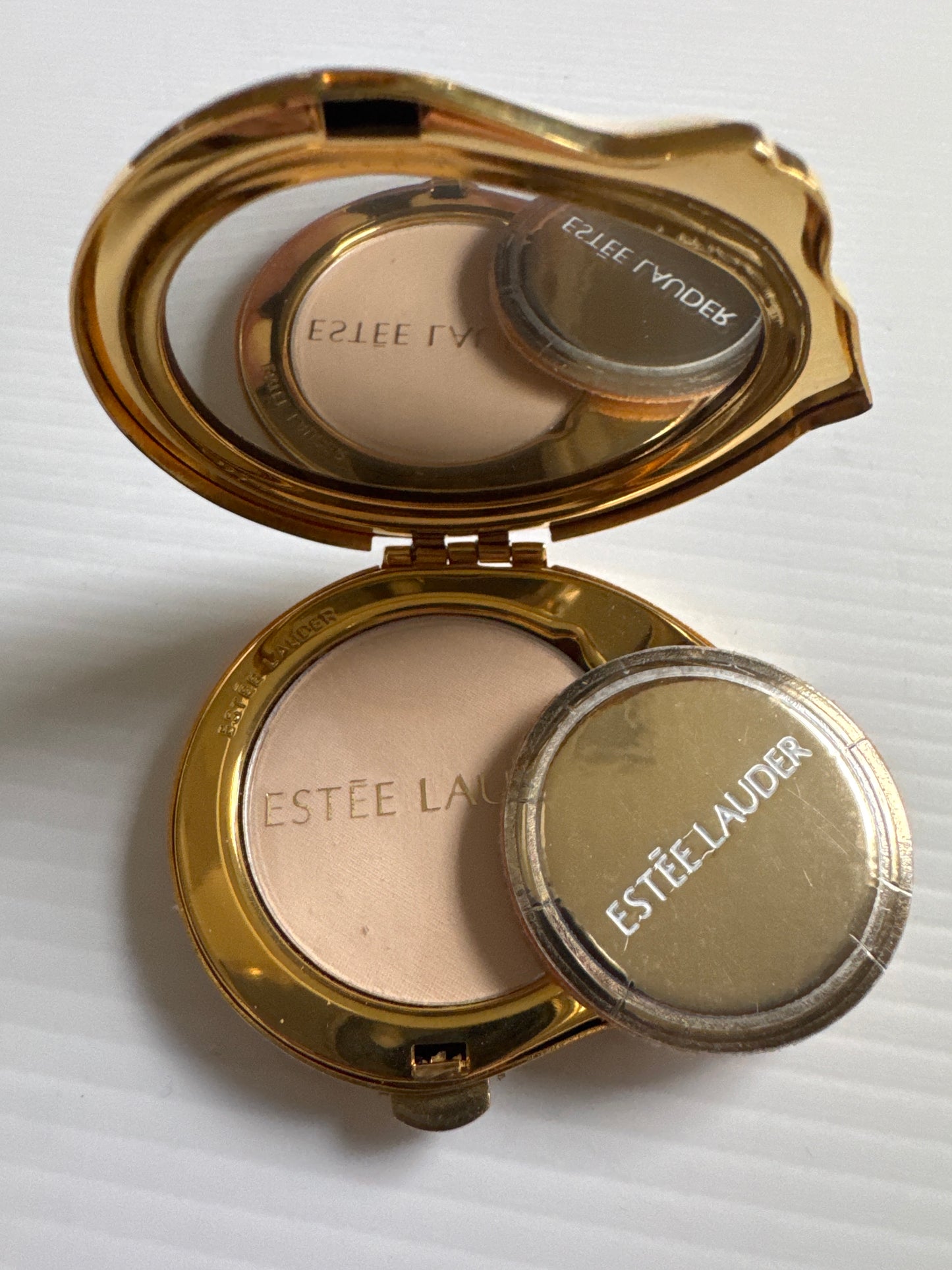 vintage Estée Lauder make up compact featuring enamel, kitty cat with pink rhinestone collar and lucidity powder