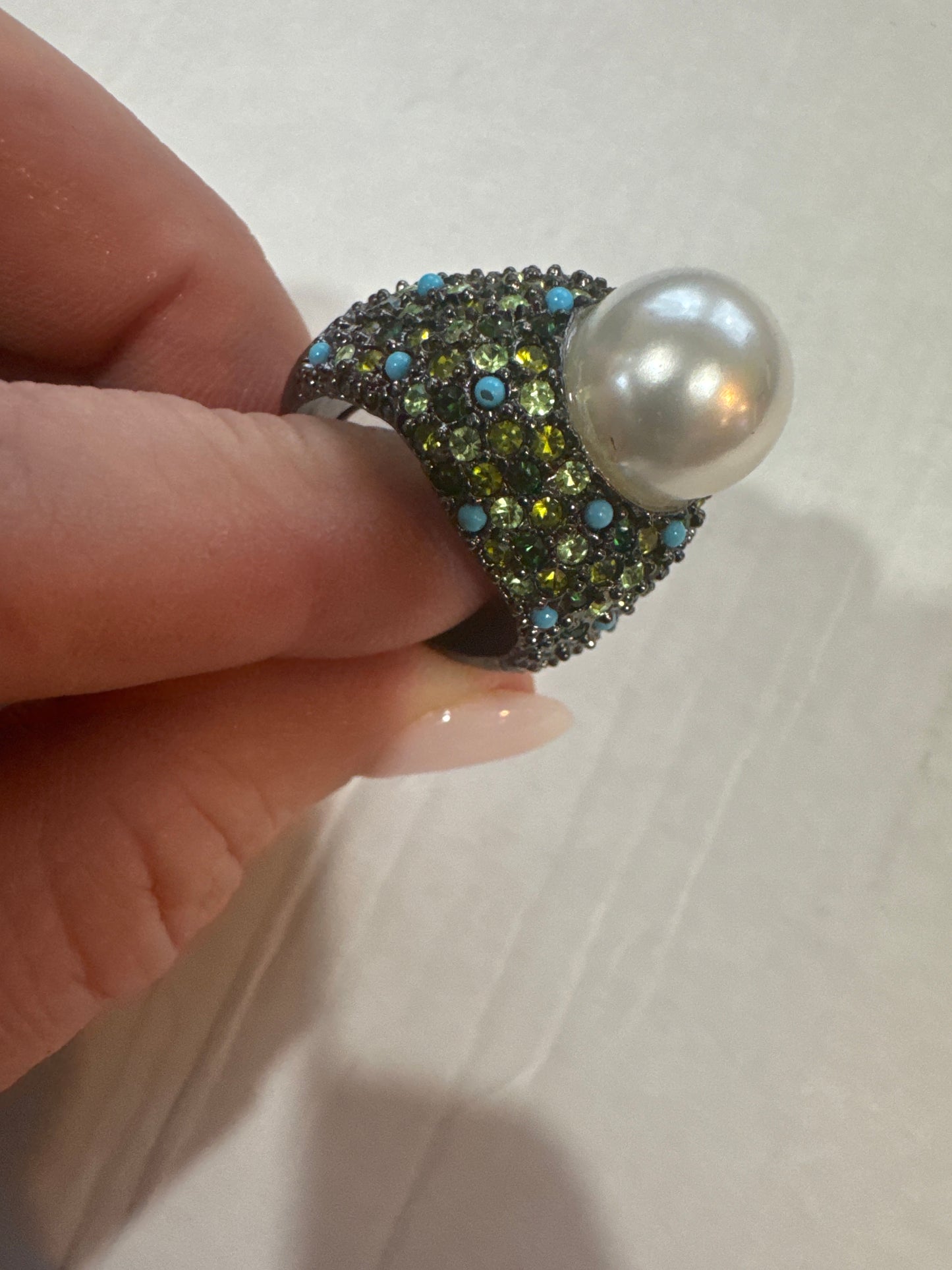 Stunning vintage KJL cocktail ring with green colored rhinestones, turquoise stones and a jumbo center pearl