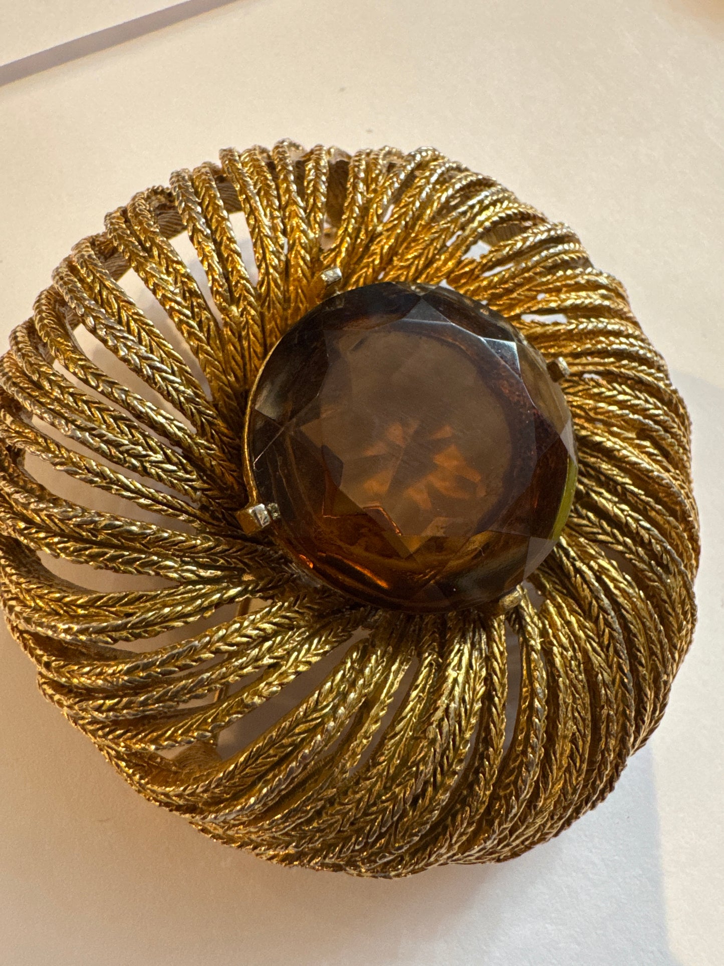 vintage Arthur Pepper brooch from 1960s in Gold tone swirl with Amber Centerstone