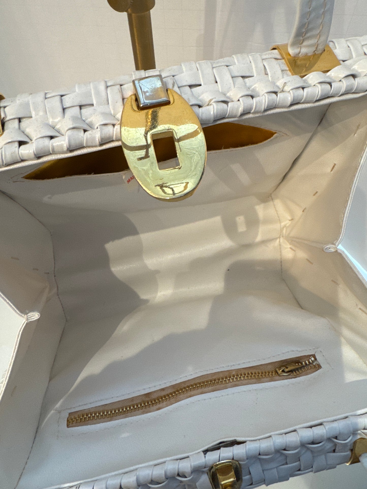 The perfect spring and summer white wicker bag with vinyl top handle.