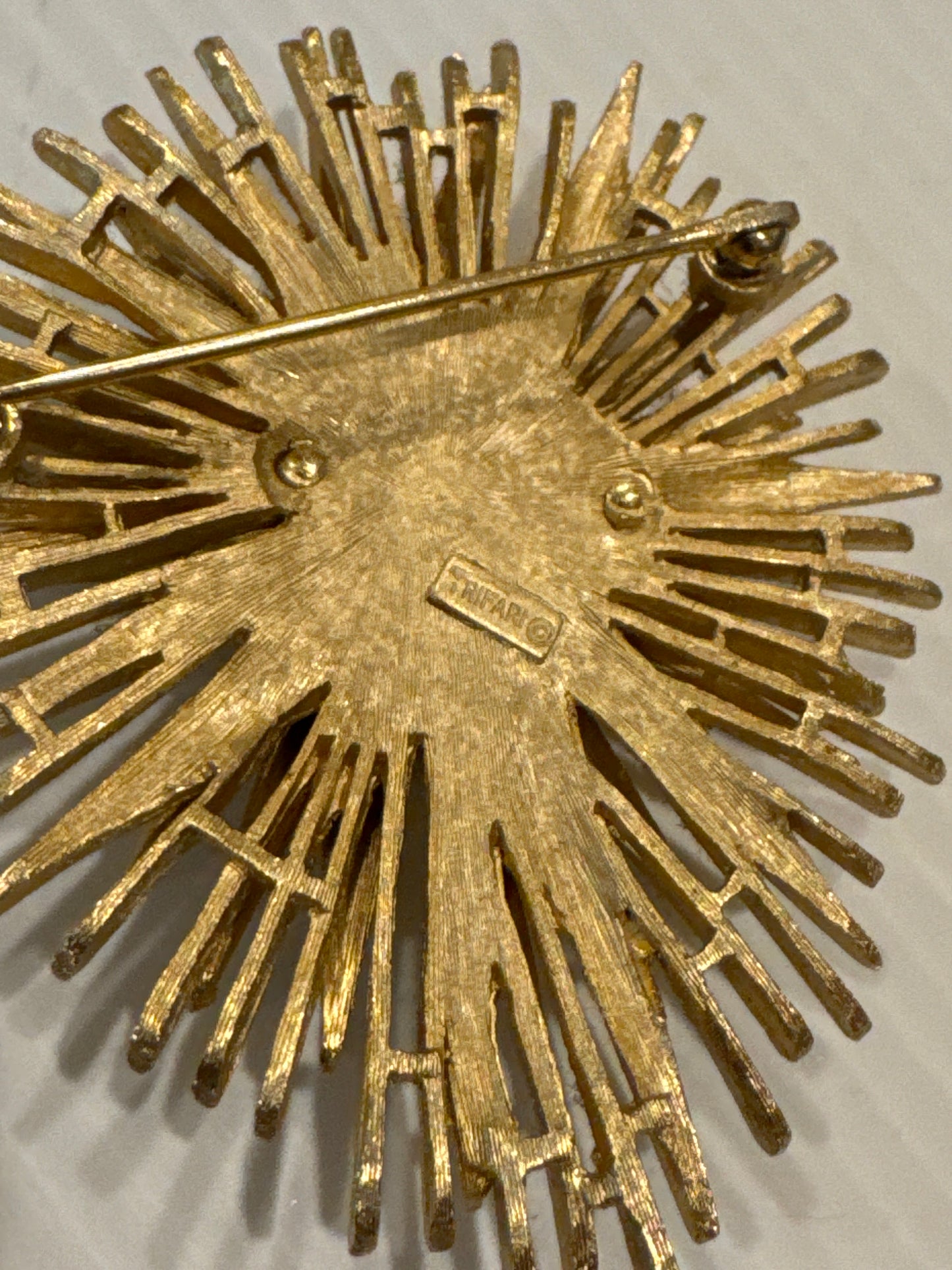 Beautiful signed Trifari Starburst brooch with emerald cut amethyst stone