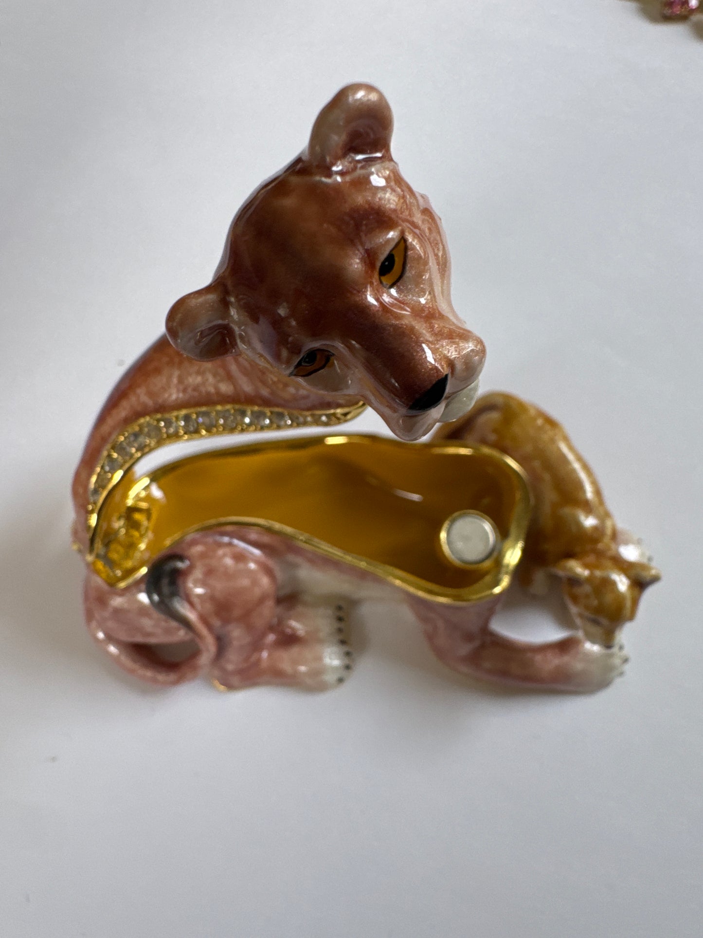 A charming 1980s enamel trinket box featuring a lioness and her cub—symbolizing protection and strength—finished with hand-painted detail and crystal accents.