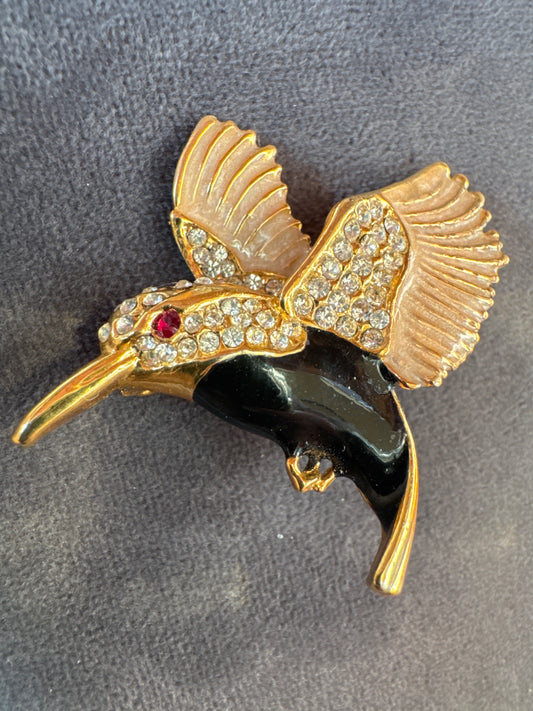 Vintage gold home with black enamel and rhinestone bird brooch. Signed USA.