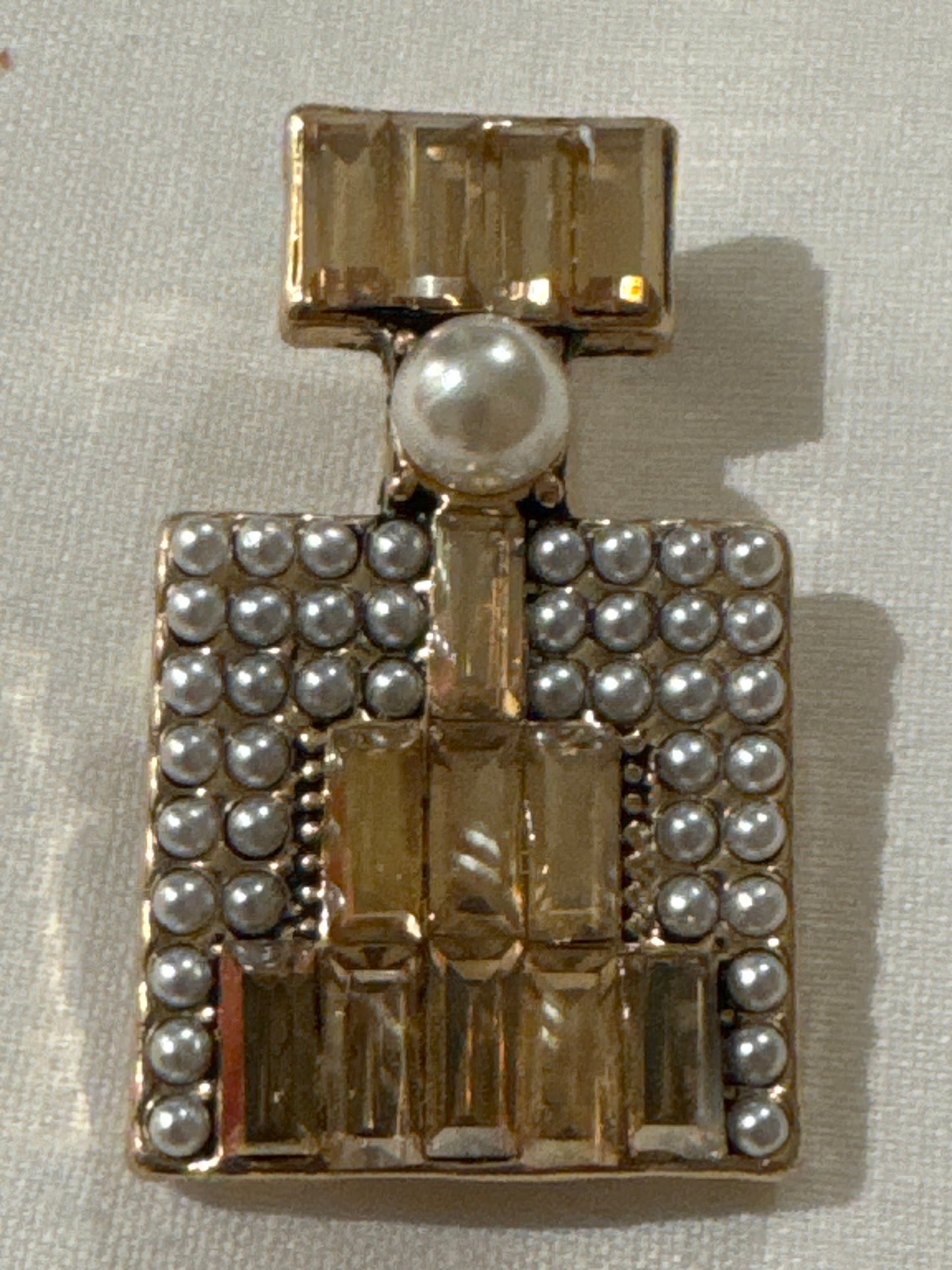 Adorable, vintage mini perfume bottle brooch with pearls and rhinestones. Sourced in Paris.