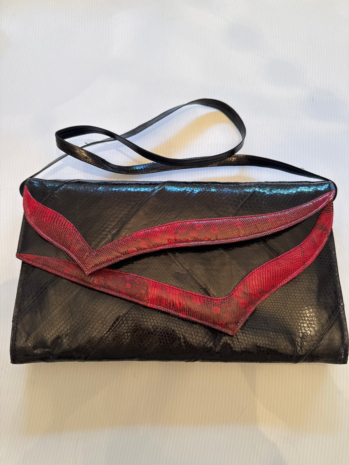 Absolutely, stunning, vintage snake skin clutch with optional shoulder strap in black and burgundy with two roomy compartments. Each compartment has its own zipper and small pocket