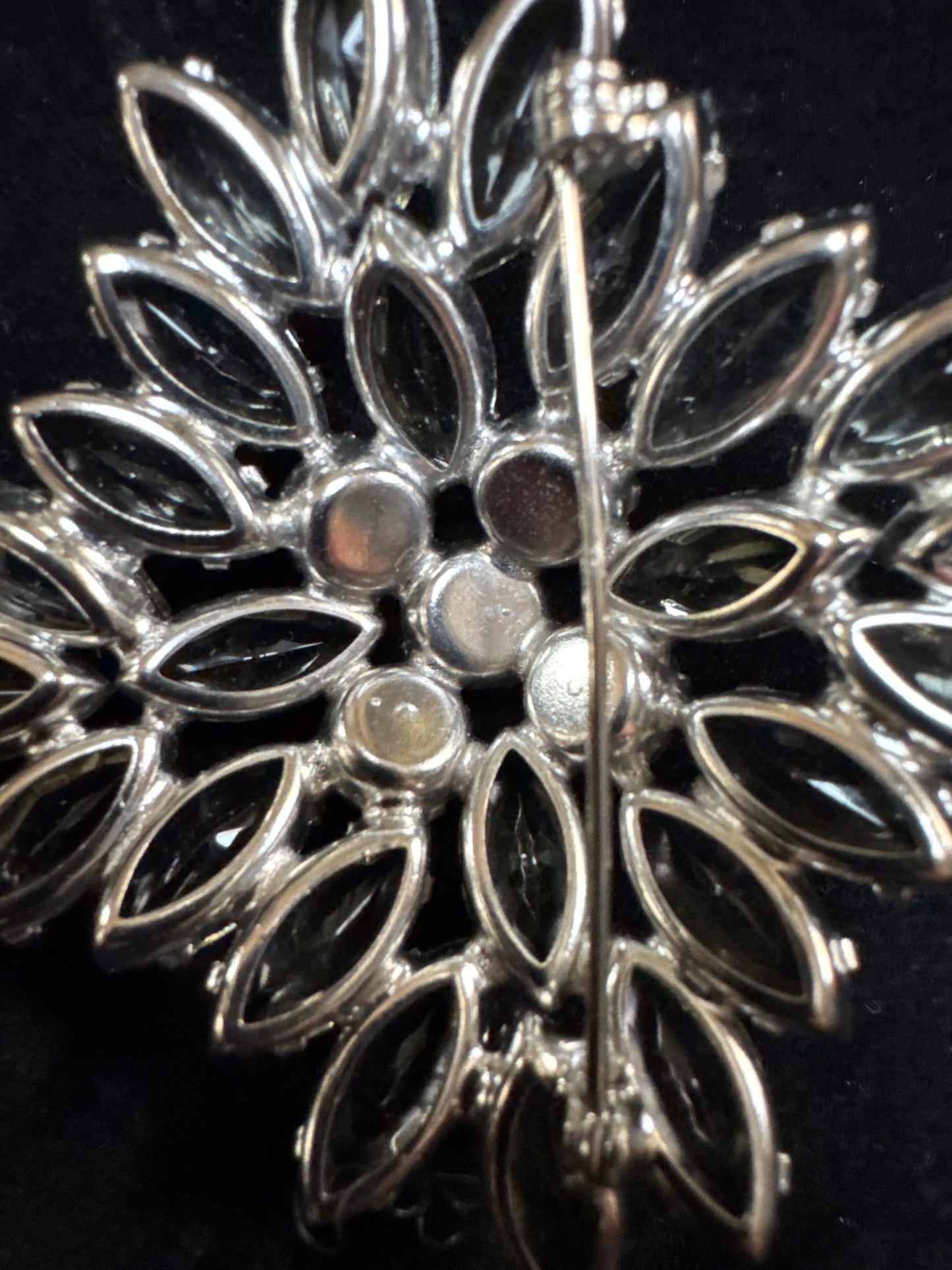 Beautiful 1950s Juliana brooch ~ slightly-domed silvertone metal and adorned by a burst of clear grey open-backed navettes. In the center are five dark Aurora Borealis stones. NYC