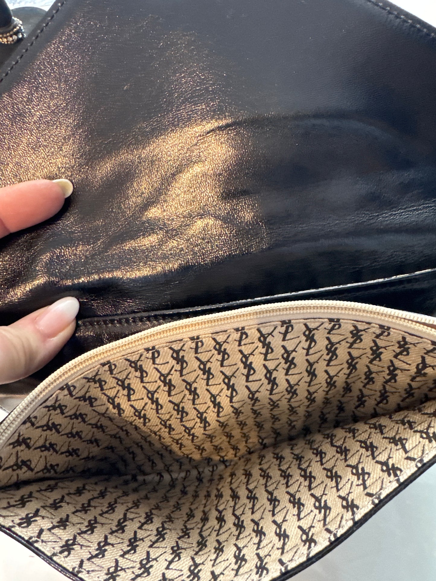 Beautiful vintage YSL lambskin leather. With zipper inside and YSL logo throughout