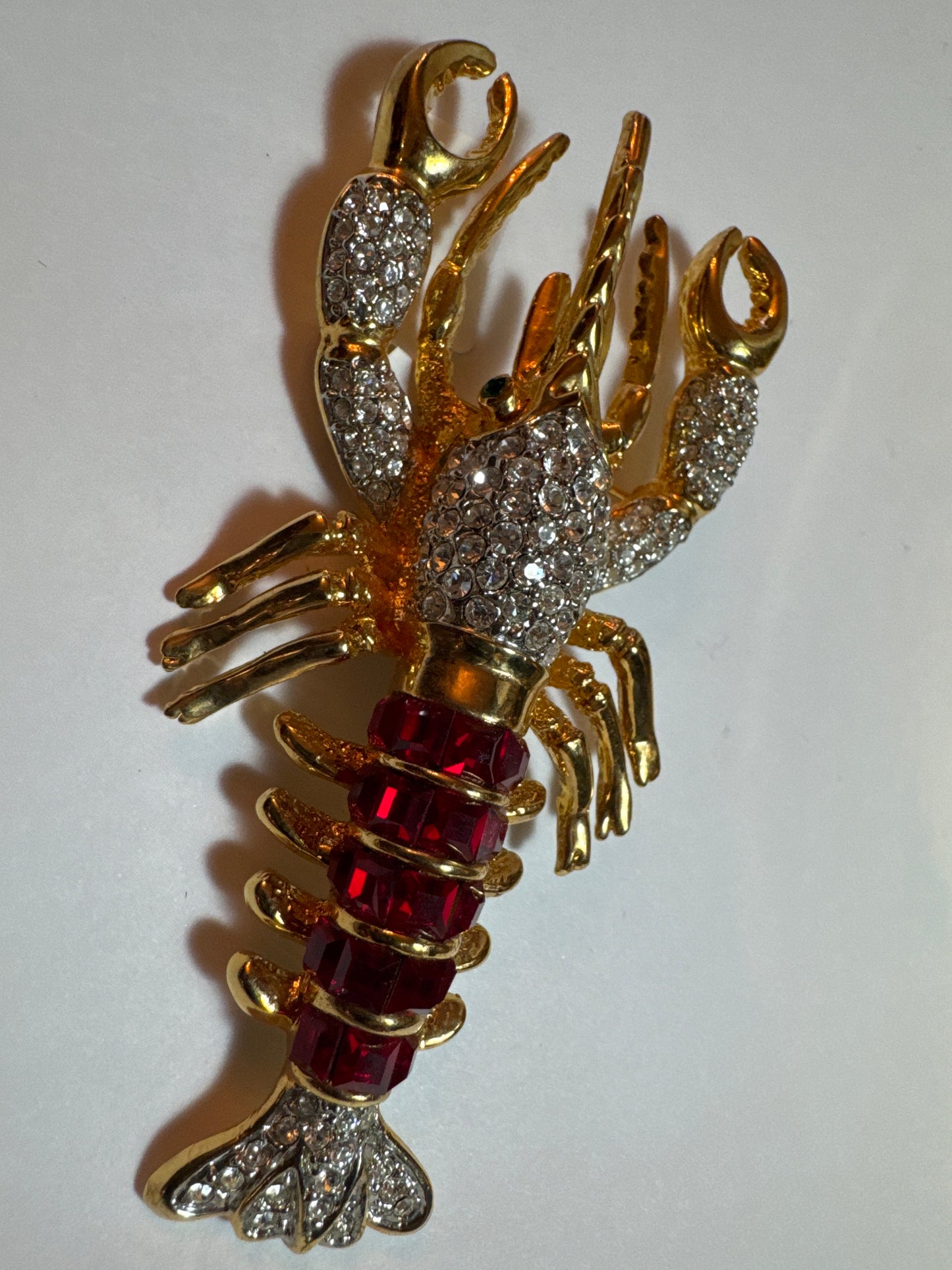 Vintage 1980s lobster brooch with red stones and green eyes and rhinestone body