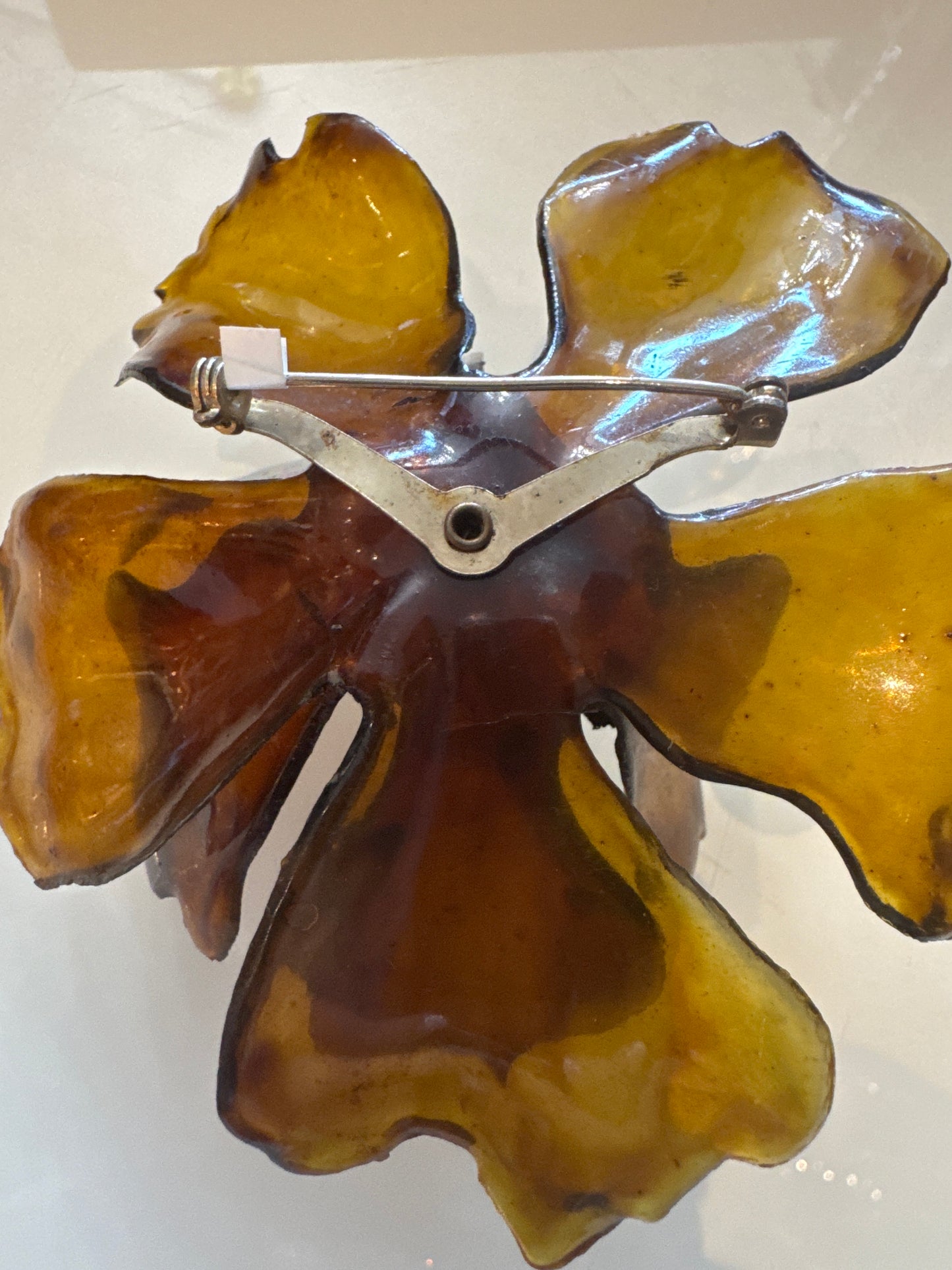 1960s giant amber colored lucite brooch with center rhinestones