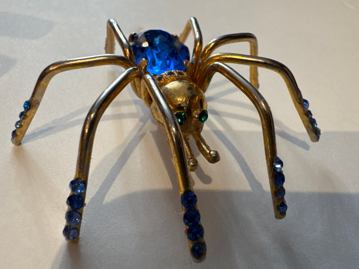 Little Miss spider, gold tone brooch with blue and green rhinestones. NYC