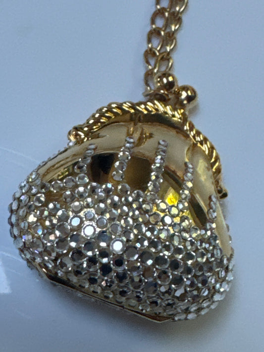 adorable 1980s must have pendant necklace by Judith Lieber. This collectible purse on a chain that opens is decorated with rhinestones.