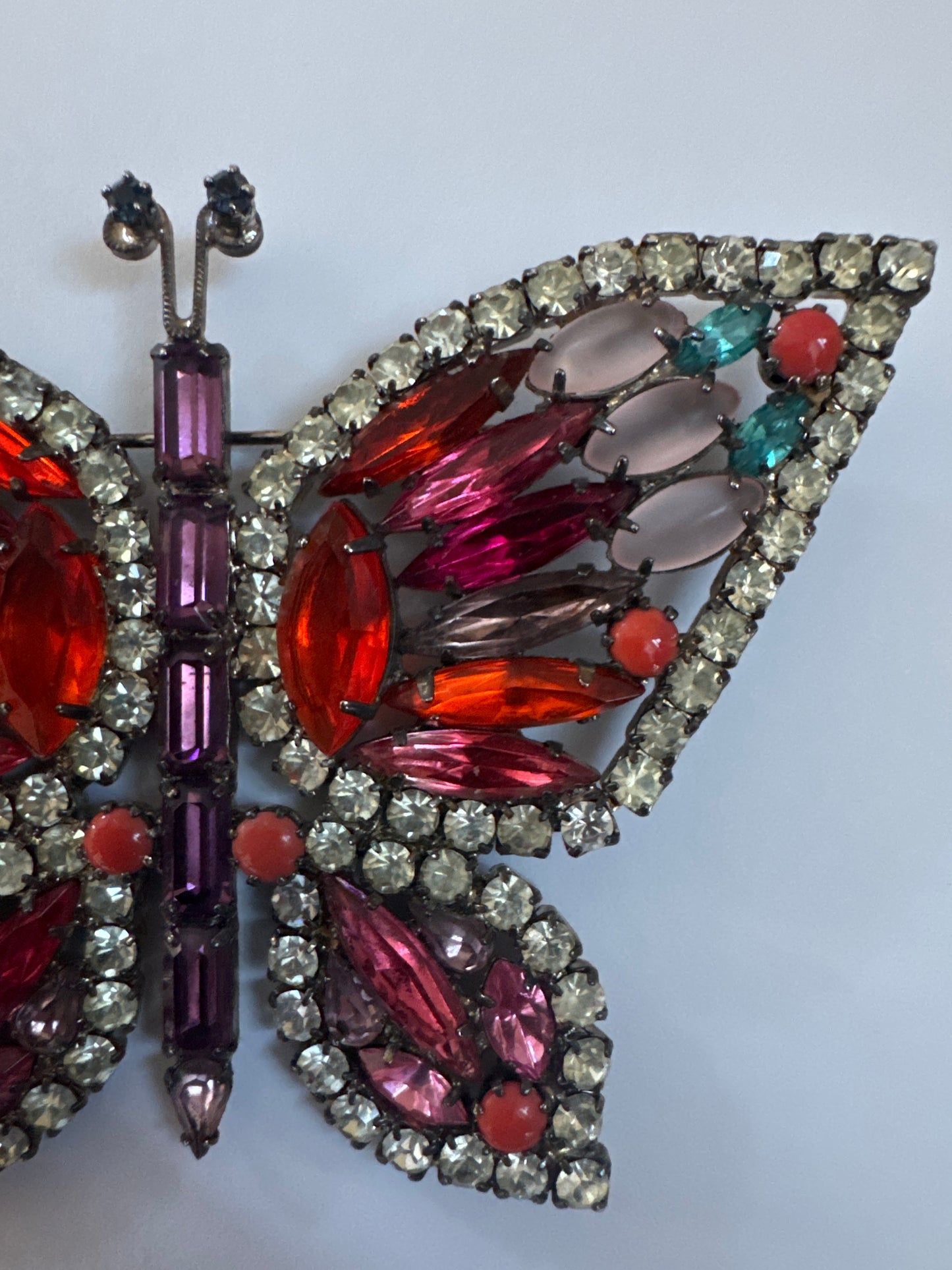 Late 1960s early 70s signed Kenneth Lane butterfly brooch featuring pink, orange and red rhinestones