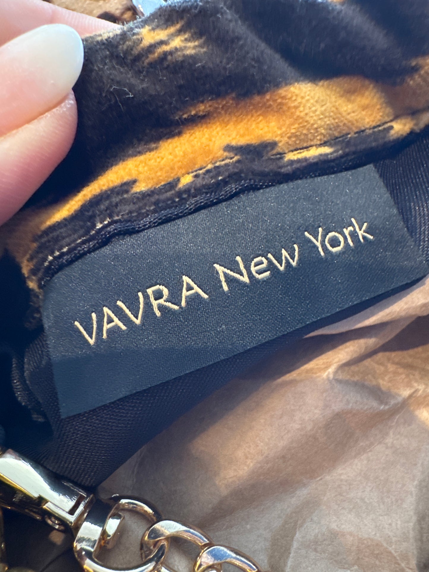 Exclusive Limited Edition Vavra New York bag collection. This print leopard fabric (large print) bag converts from clutch to shoulder strap with chunky chain shown. Black lining with interior pocket.