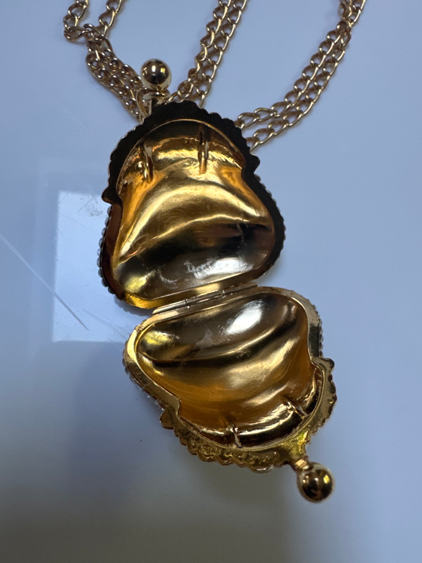 adorable 1980s must have pendant necklace by Judith Lieber. This collectible purse on a chain that opens is decorated with rhinestones.