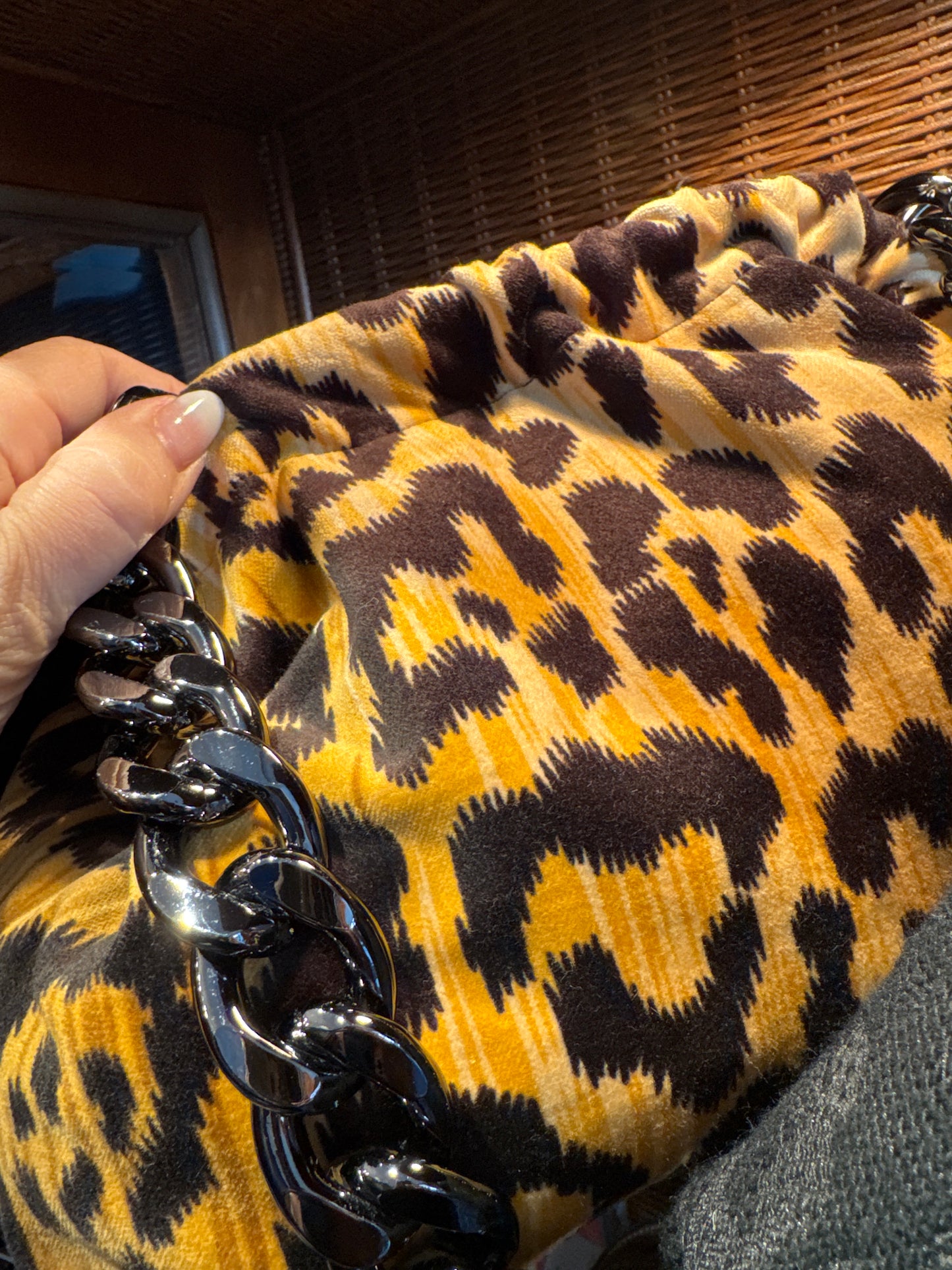 Exclusive Limited Edition Vavra New York bag collection. This print leopard fabric (large print) bag converts from clutch to shoulder strap with chunky chain shown. Black lining with interior pocket.