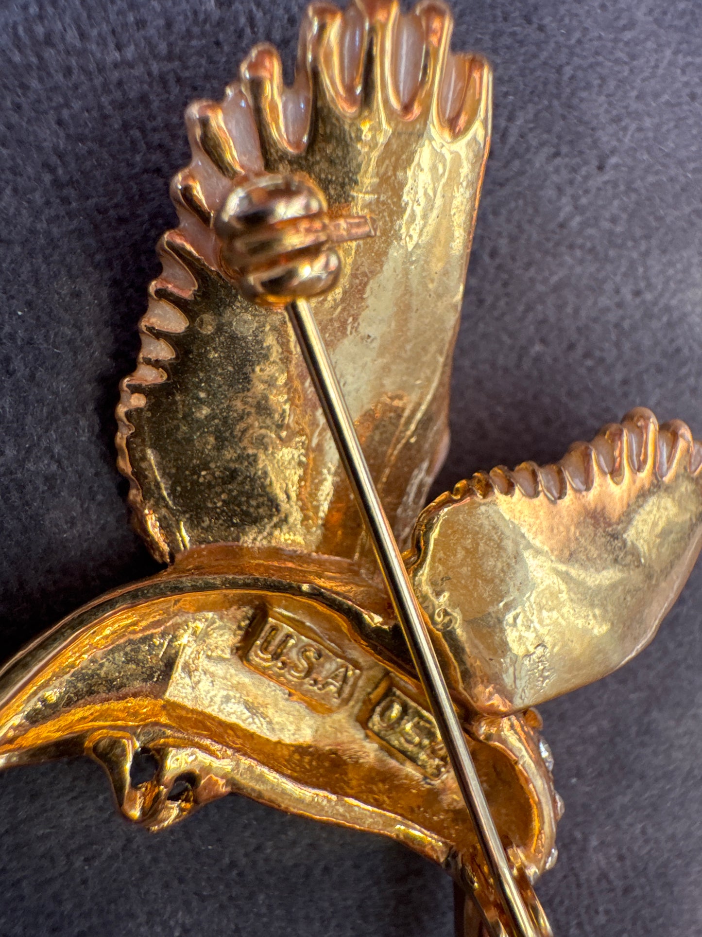 Vintage gold home with black enamel and rhinestone bird brooch. Signed USA.