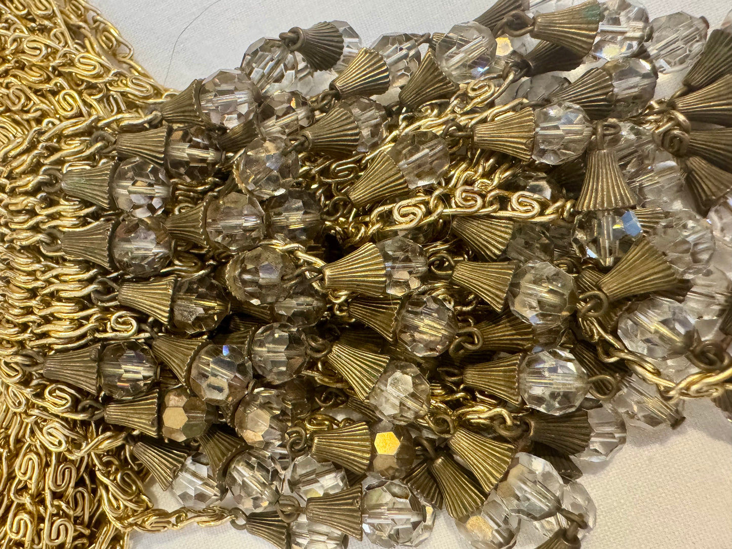 show stopping gold toe, vintage multi chain necklace with dangle rhinestones. Such a statement piece. Sourced in Paris.