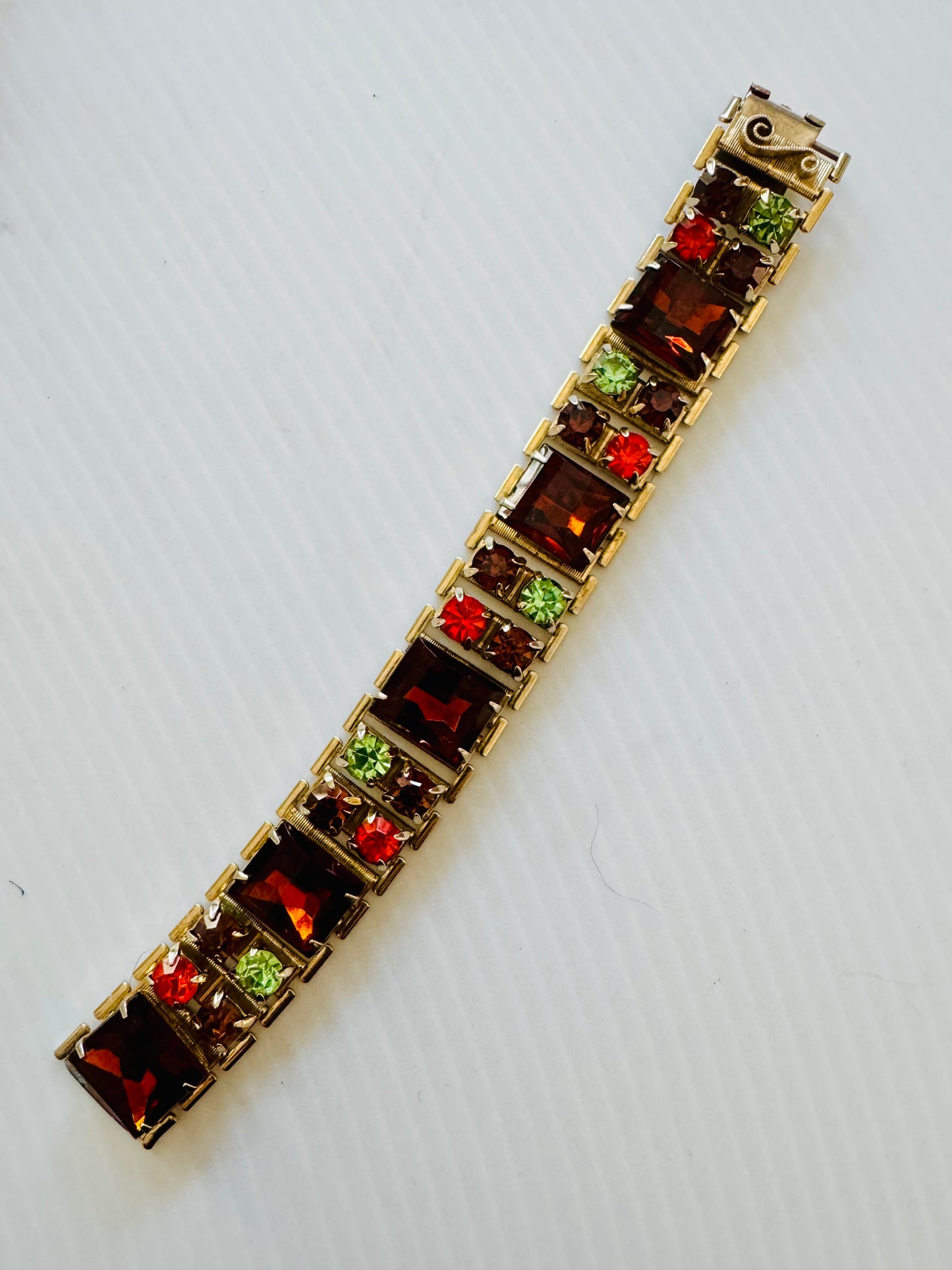 Beautiful vintage bracelet in gold tone with amber, orange and green rhinestones. Sourced in Paris.
