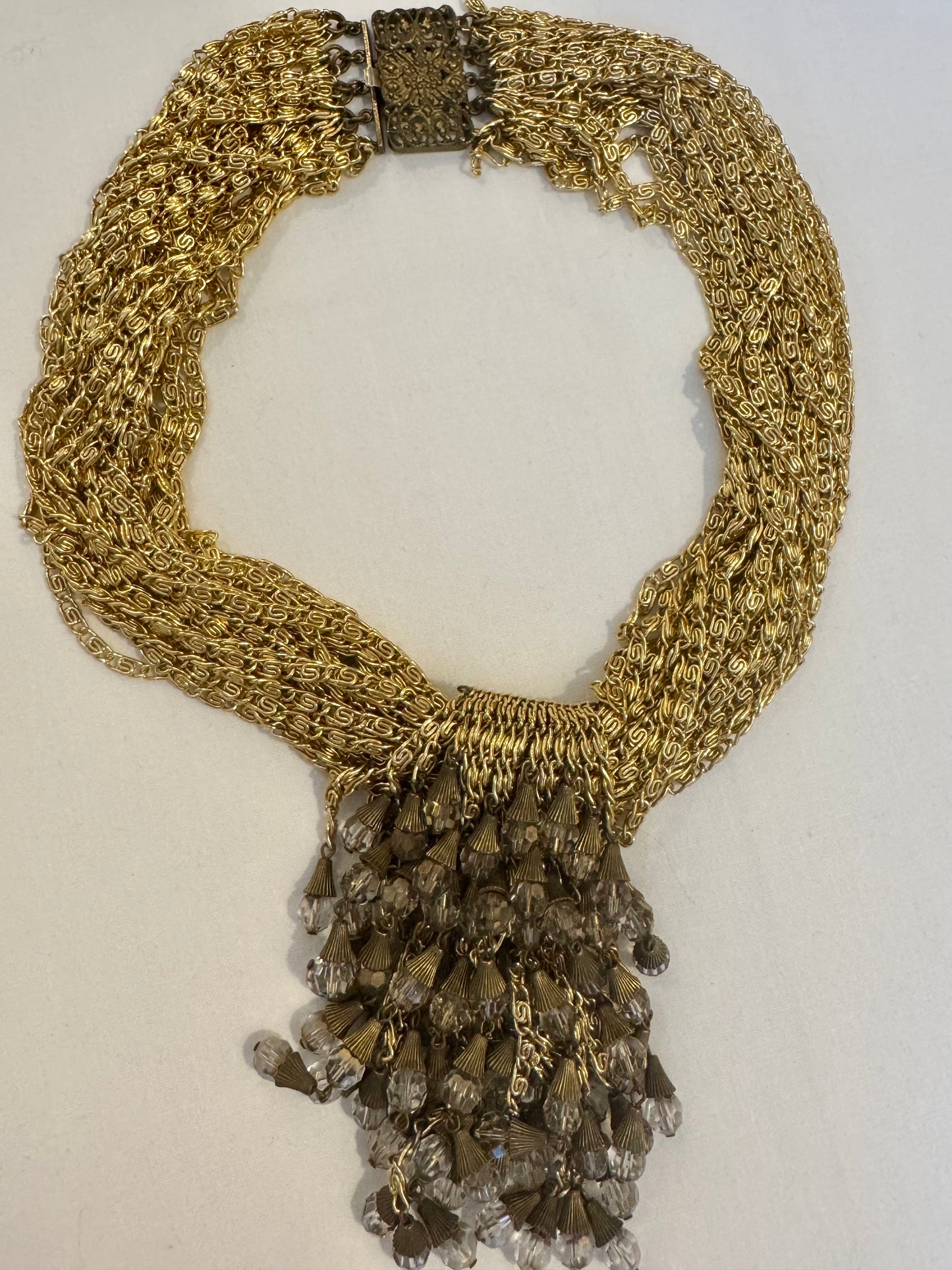 show stopping gold toe, vintage multi chain necklace with dangle rhinestones. Such a statement piece. Sourced in Paris.