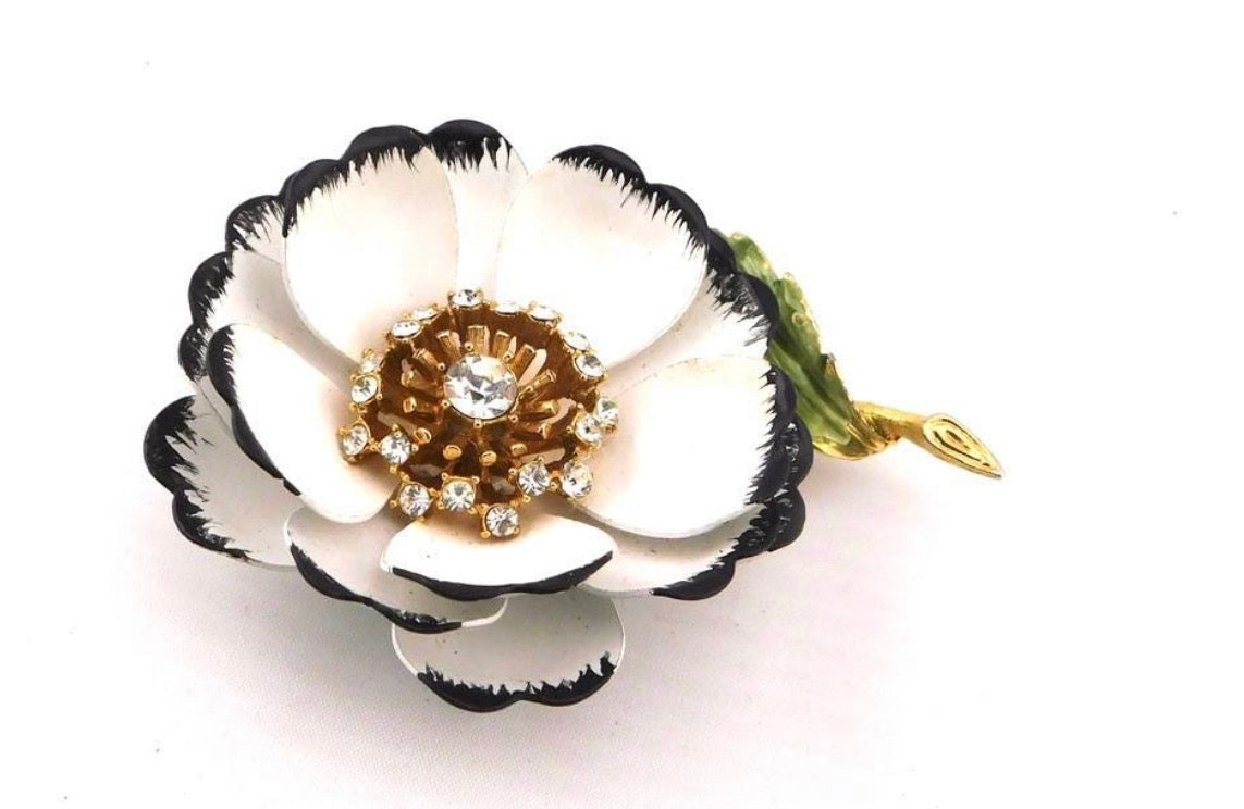Gorgeous White and Black enamel Flower Brooch.
Multi-layered petals of white w/ black with Gold tone & clear rhinestones pistils.
