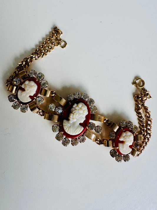 Wow Factor 1950s cameo bracelet with three cameos surrounded by rhinestones on a double gold tone chain