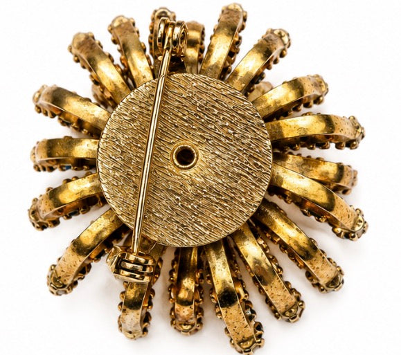 1960s multi layered starburst brooch with green blue and clear rhinestones on both sides of the starburst. Rare piece.