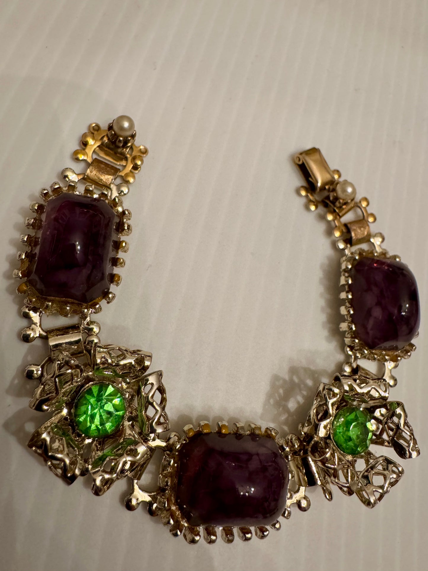 fabulous vintage 1950s gold tone with green rhinestone purple stones and pearl bracelet