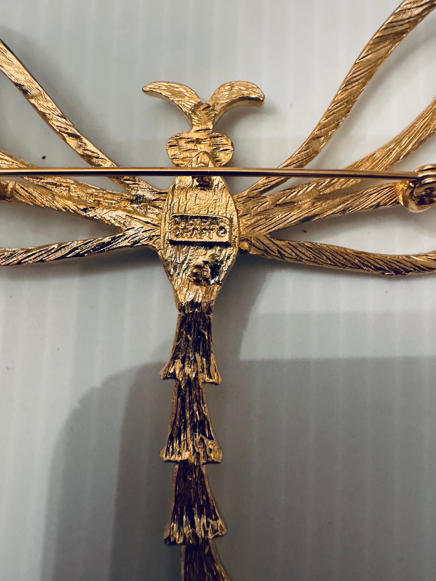 Jumbo vintage firefly gold tone brooch with black enamel body and rhinestone eyes. Signed piece by Ultracraft.