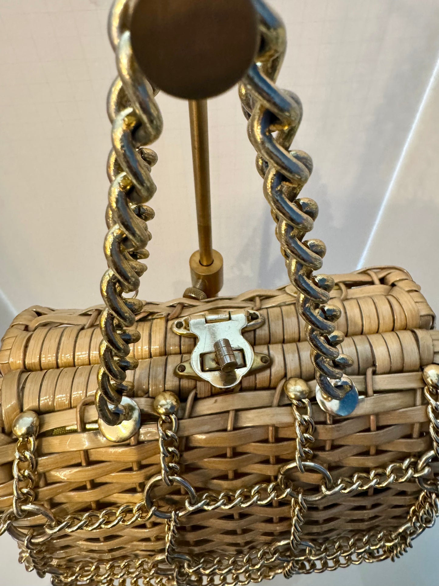 Beautiful 1950s wicker bag with gold chain decoration on front and gold hardware. Yellow fabric inside has some slight imperfection. Please see last photo Just a gorgeous piece.