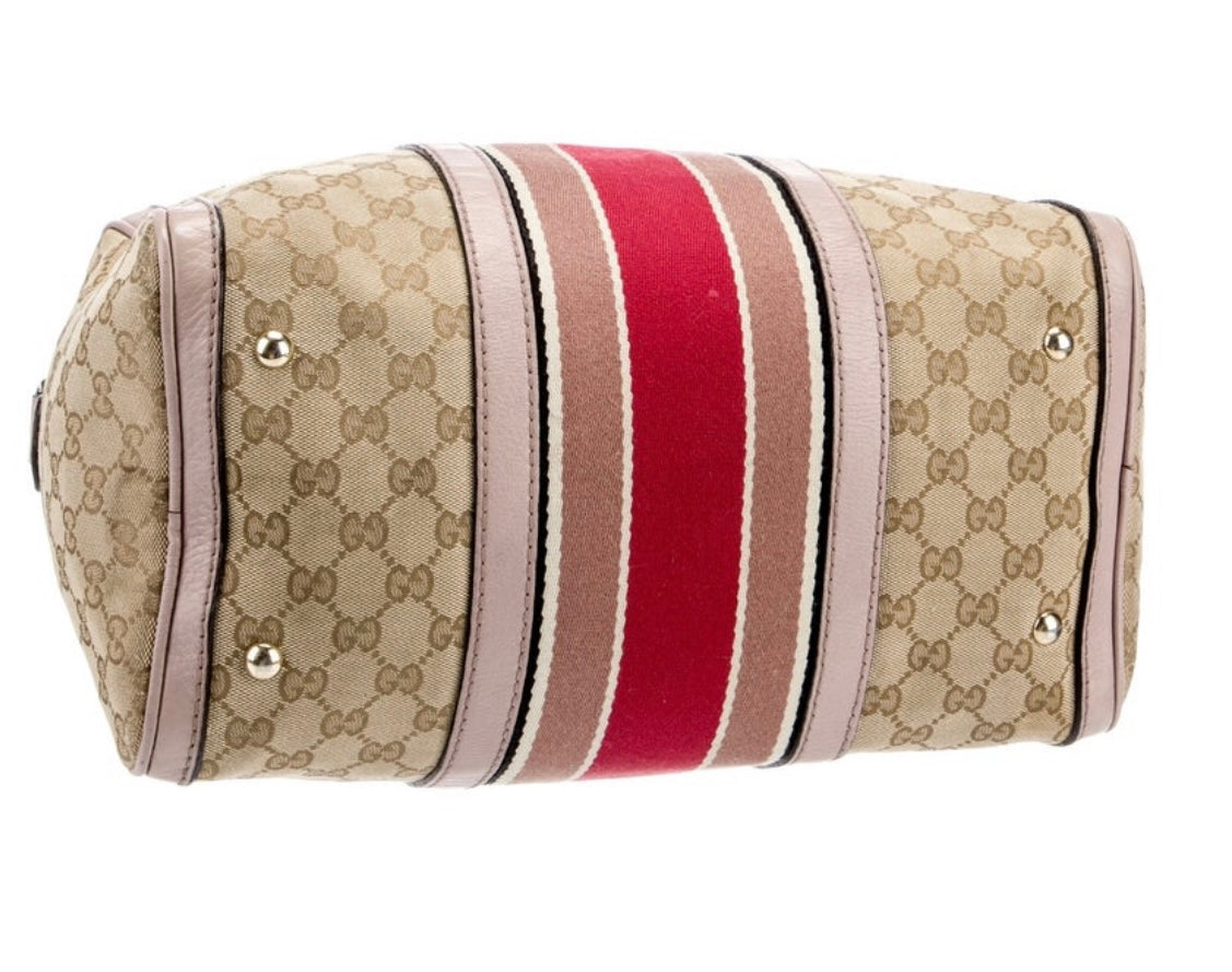 Gucci Boston Bag with leather handles and crossbody strap. 3 interior pockets.