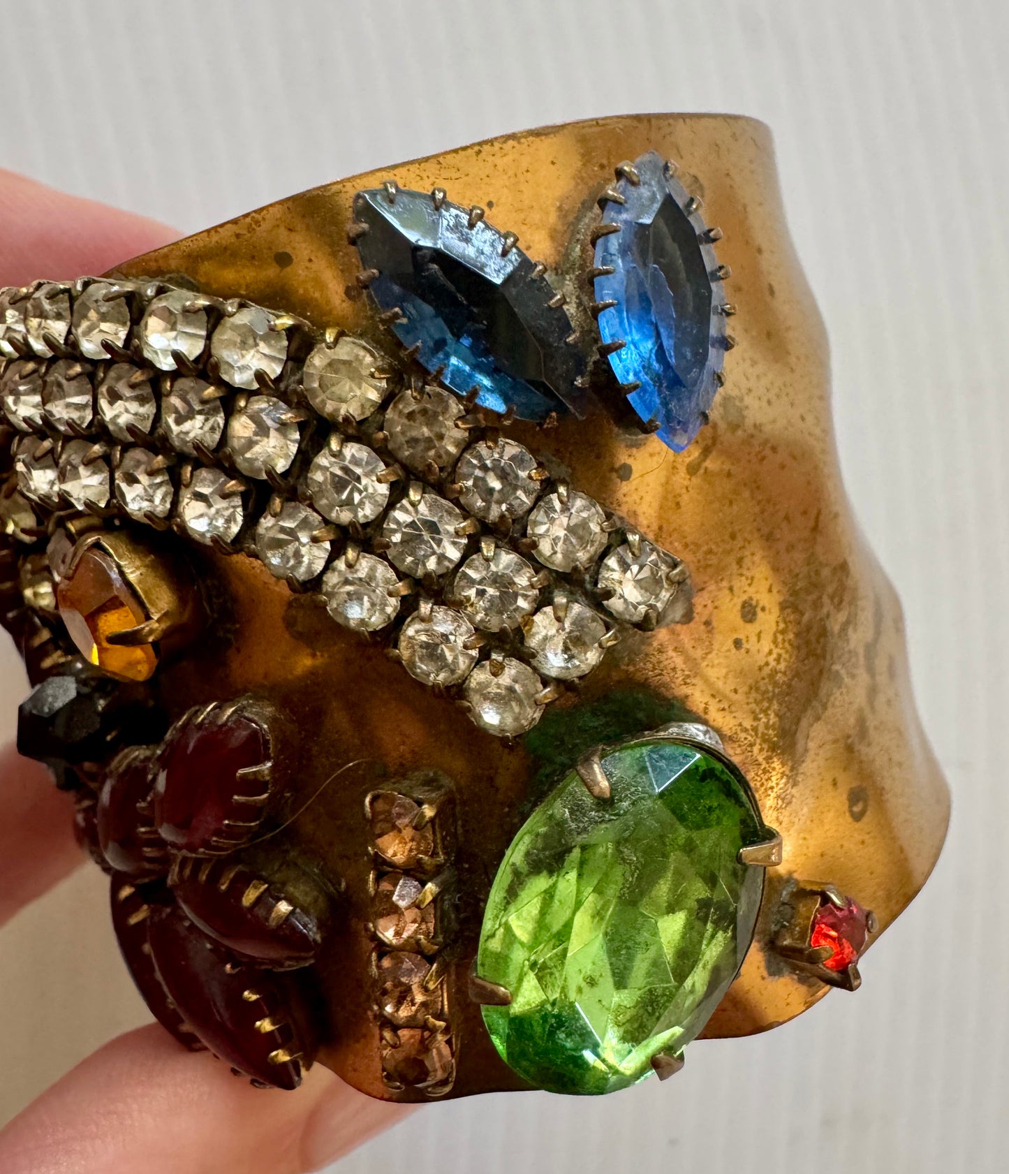 gorgeous vintage hammered cuff bracelet with multicolor rhinestones. Sourced in Paris.